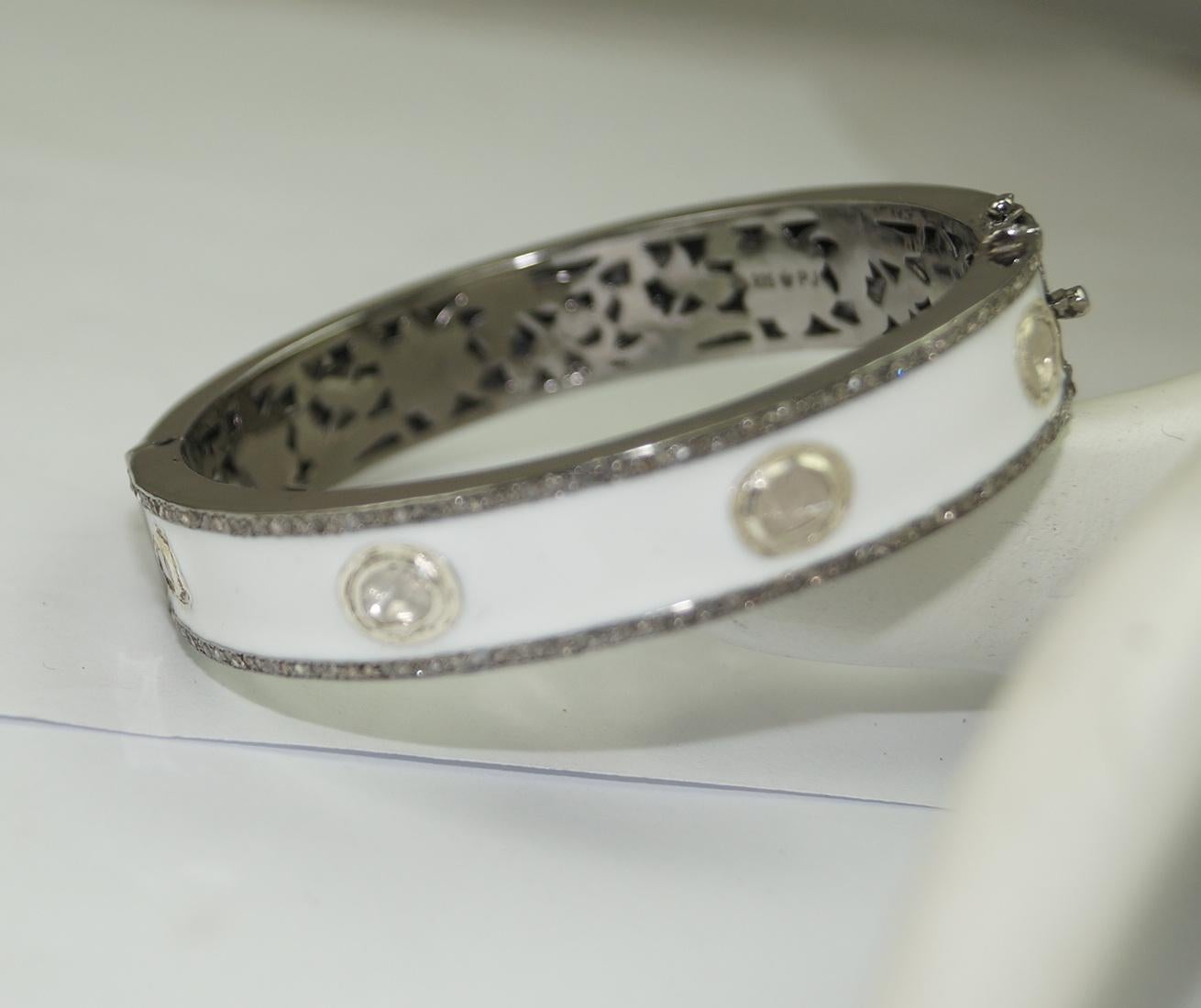 This elegant, hinged bangle consists of:

Diamond- 4.10cts
Diamond type: Uncut and rose cut diamonds
Diamond color: White 
Diamond Certificate- Certified Natural
Metal: Silver
Metal Purity: Sterling Silver or 92.5% Pure
Color of silver- Oxidized