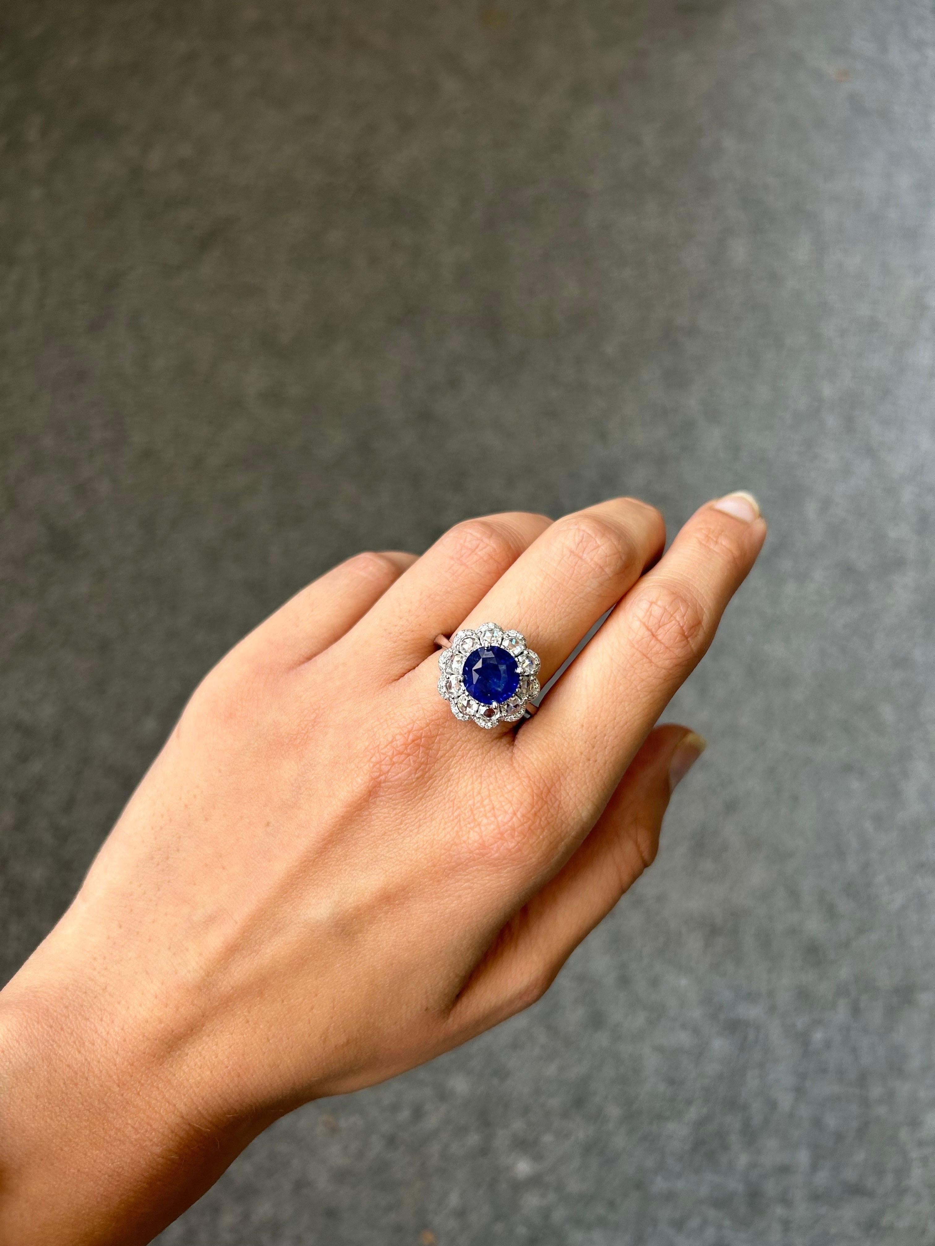 This custom-made 18k gold cocktail cluster ring features an exceptional display of craftsmanship and imaginative design, perfect for those who love the incredible color of high-quality sapphire. A round faceted cut Sri Lankan deep royal blue