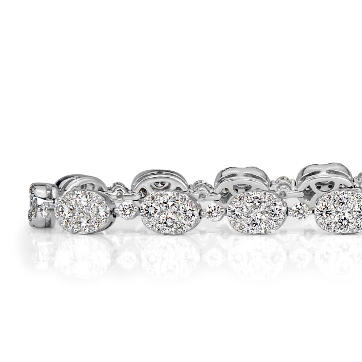 Handcrafted in 14k white gold, this stunning diamond bracelet features 4.11ct of round brilliant cut diamonds hand set in a lovely oval shaped design. The diamonds are  graded at F-G in color, VS1-VS2 in clarity.
