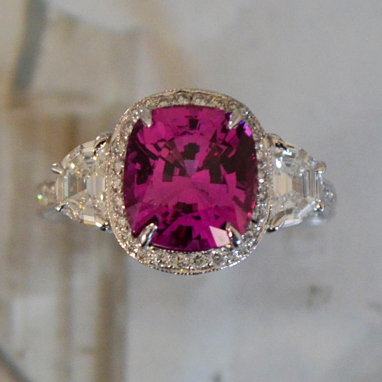 Main Stone Info:

1. Carat Weight: 4.1+ 

2. Color: Pink

3. Tone:  Medium - Nice, 7.0 Out of 10

4. Hue: Fancy Intense Slightly Purplish Pink.

3. Clarity:  Excellent clarity, no inclusions to the eye. VS if diamond rating.

4. Cut: This stone has