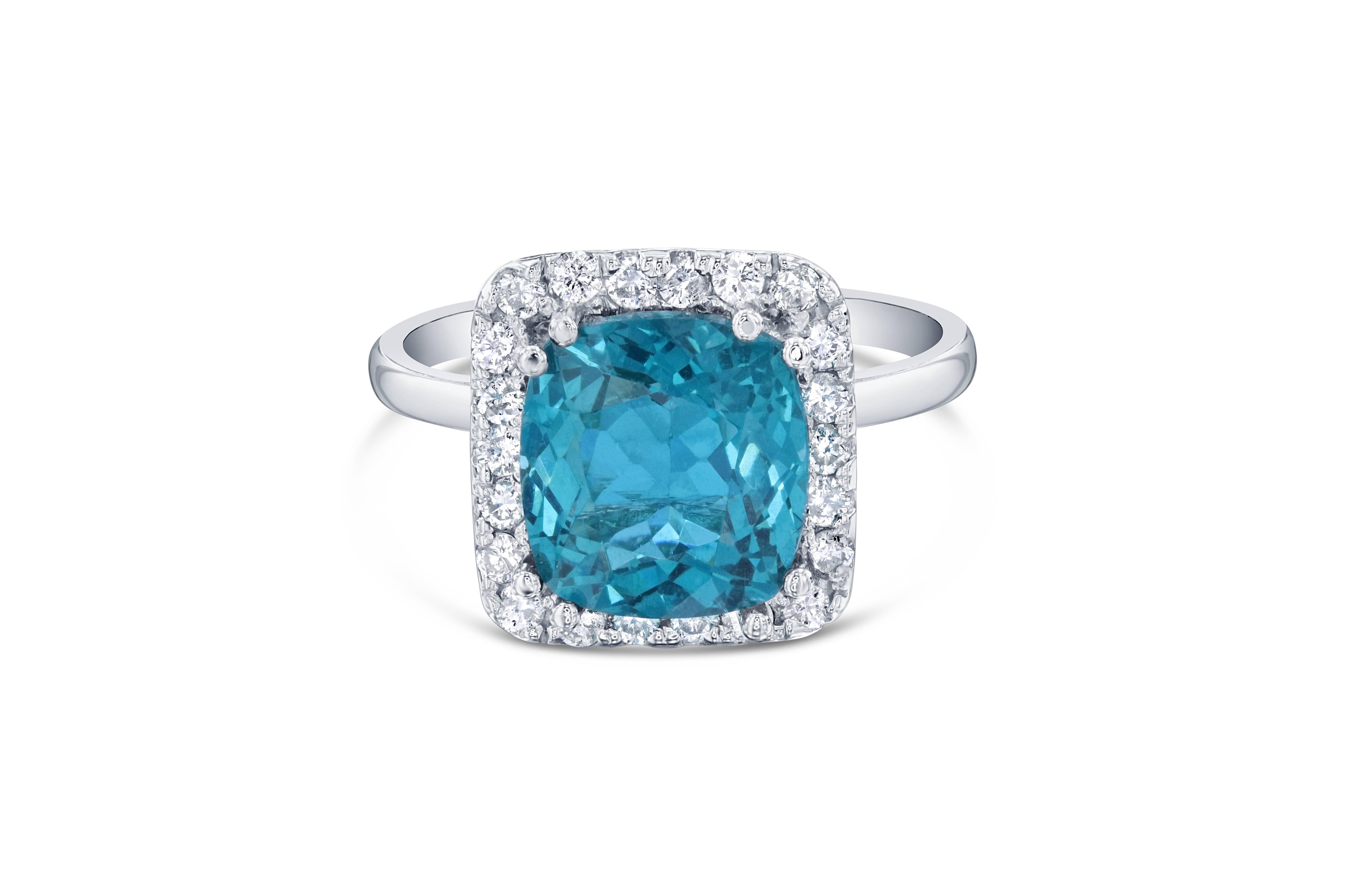 Gorgeous Halo Apatite and Diamond Ring.  This ring has a 3.71 carat cushion cut Apatite in the center of the ring and is surrounded by 22 Round Cut Diamonds that weigh 0.41 carat Clarity: SI2, Color:F.  The total carat weight of the ring is 4.12