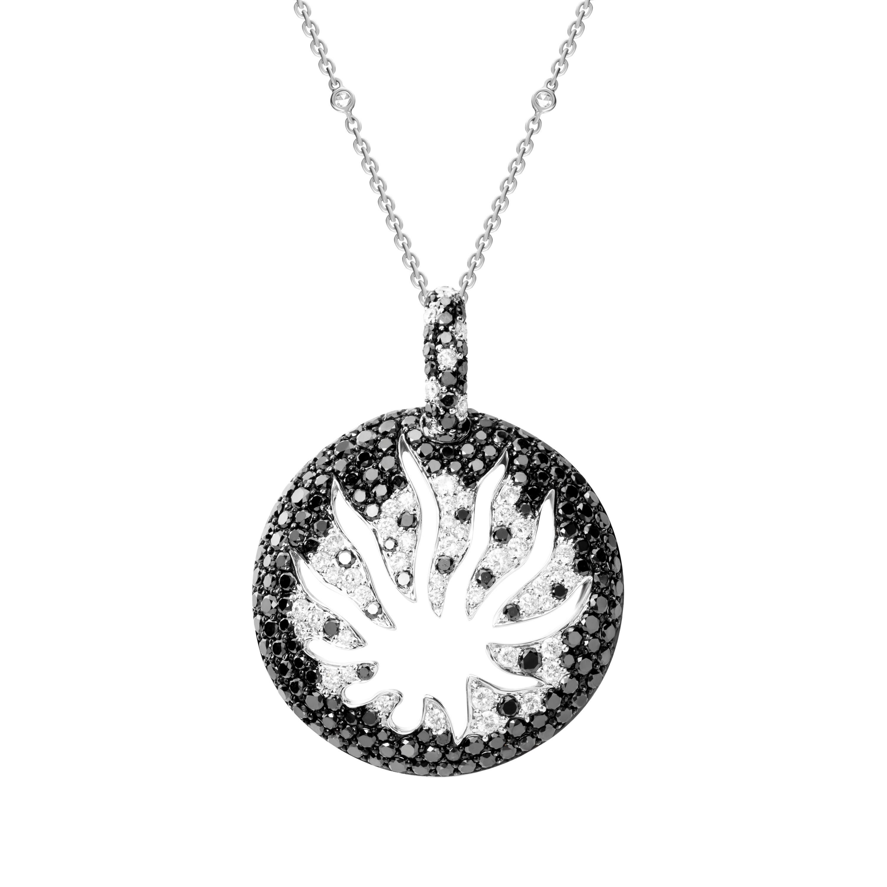 Made from 18-karat white gold, this medallion pendant necklace beams with luminous black and white diamonds weighing a total of 4.12 carats and is traced with spokes symbolizing rays of light in the constellation.  0.63 carats of rose cut round