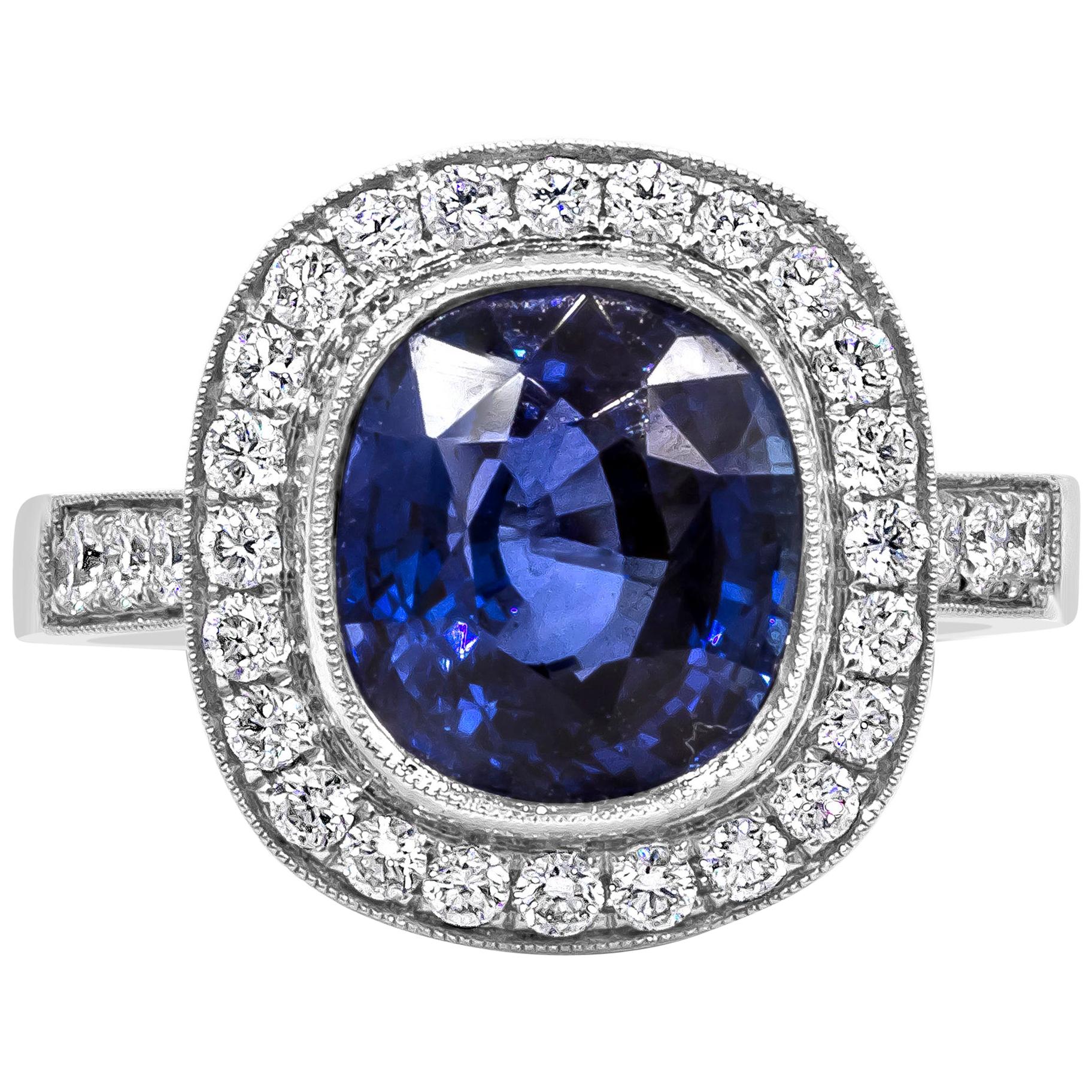 4.12 Carats Cushion Cut Royal Blue Sapphire with Diamond Halo Engagement Ring For Sale
