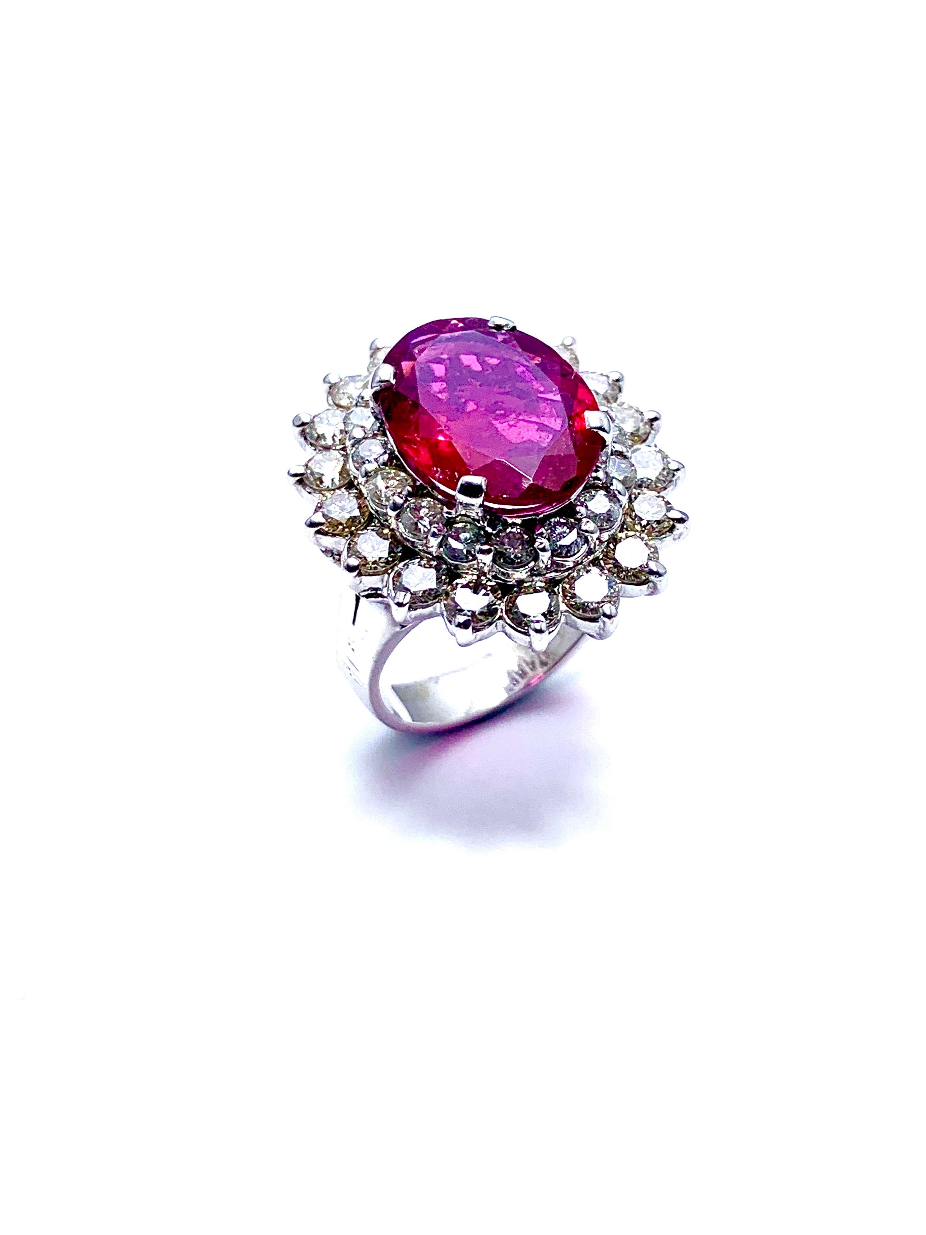 A gorgeous Rubellite Tourmaline and Diamond ring!  The vibrant faceted oval 4.12 carat Rubellite is set in four prongs, with two rows of of round brilliant cut Diamonds totaling 2.60 carats.  The diamonds are H-I color, SI clarity.  The ring