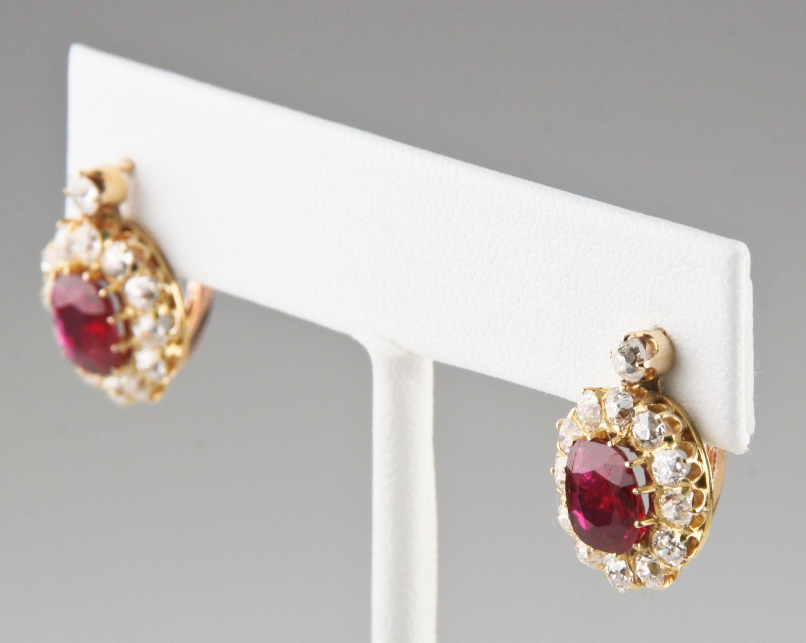 Gorgeous 18k Yellow Gold Drop Earrings Feature Two Cushion-Cut Unaltered Rubies (TRW = 2.30 ct)
Also Feature Haloes of Round Brilliant Prong-Set Diamonds in Delicate Yellow Gold Gallery
Total Diamond Weight = 1.82 ct
Rubies are completely natural,