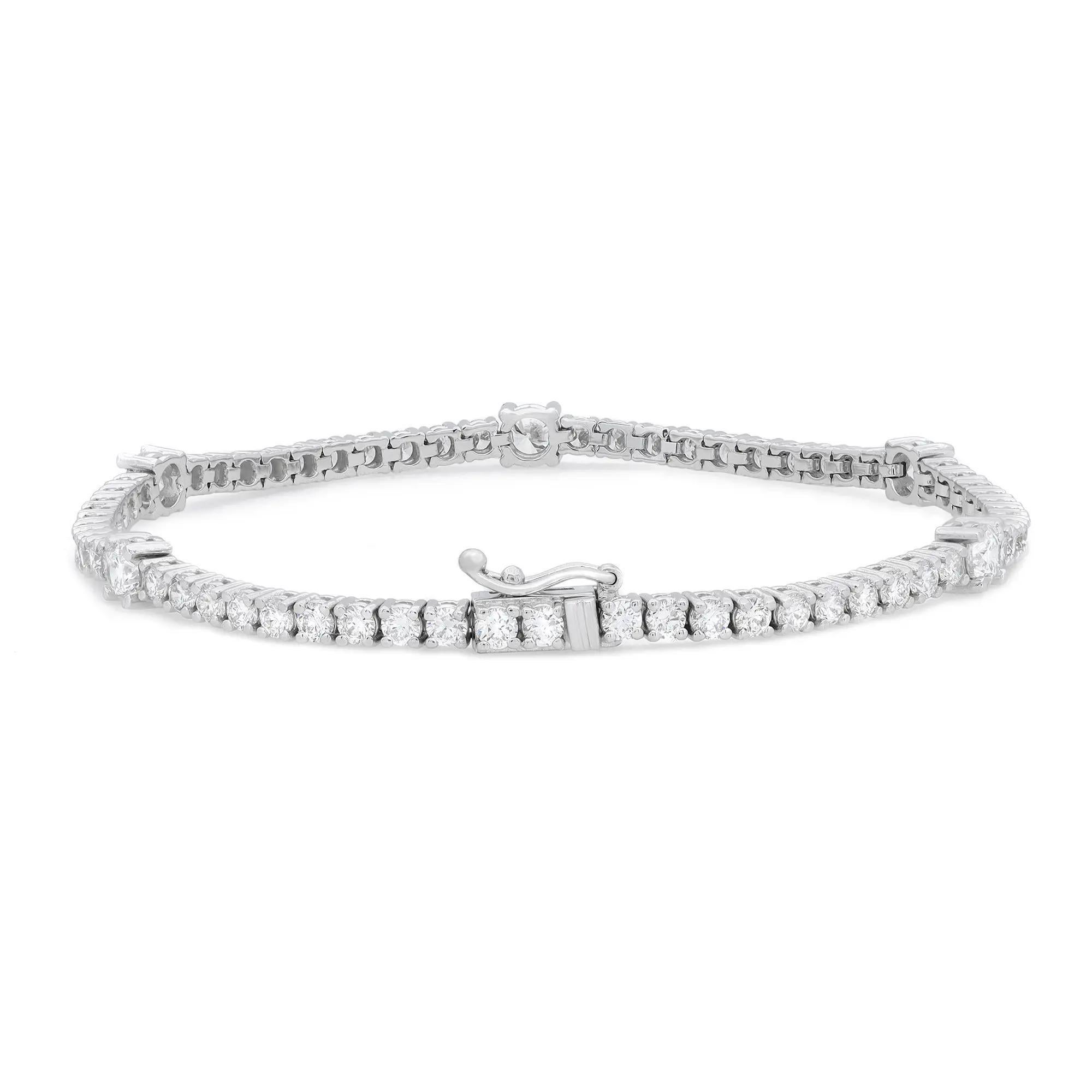 Classic yet elegant, this breathtaking tennis bracelet is crafted in 14K white gold with 66 prong set dazzling round brilliant cut diamonds. Total diamond weight: 4.12 carats with 5 diamonds size 20pt and the rest 4pt each. The bright white diamonds
