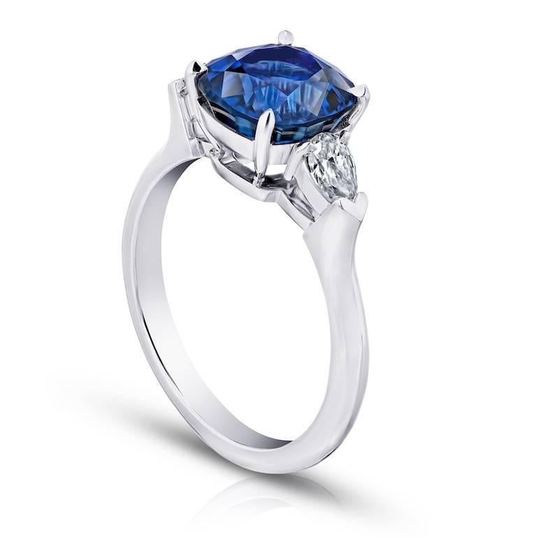 4.13 cushion blue sapphire with two pear shape diamonds (EF/VVS) weighing .38 carats in a platinum ring
