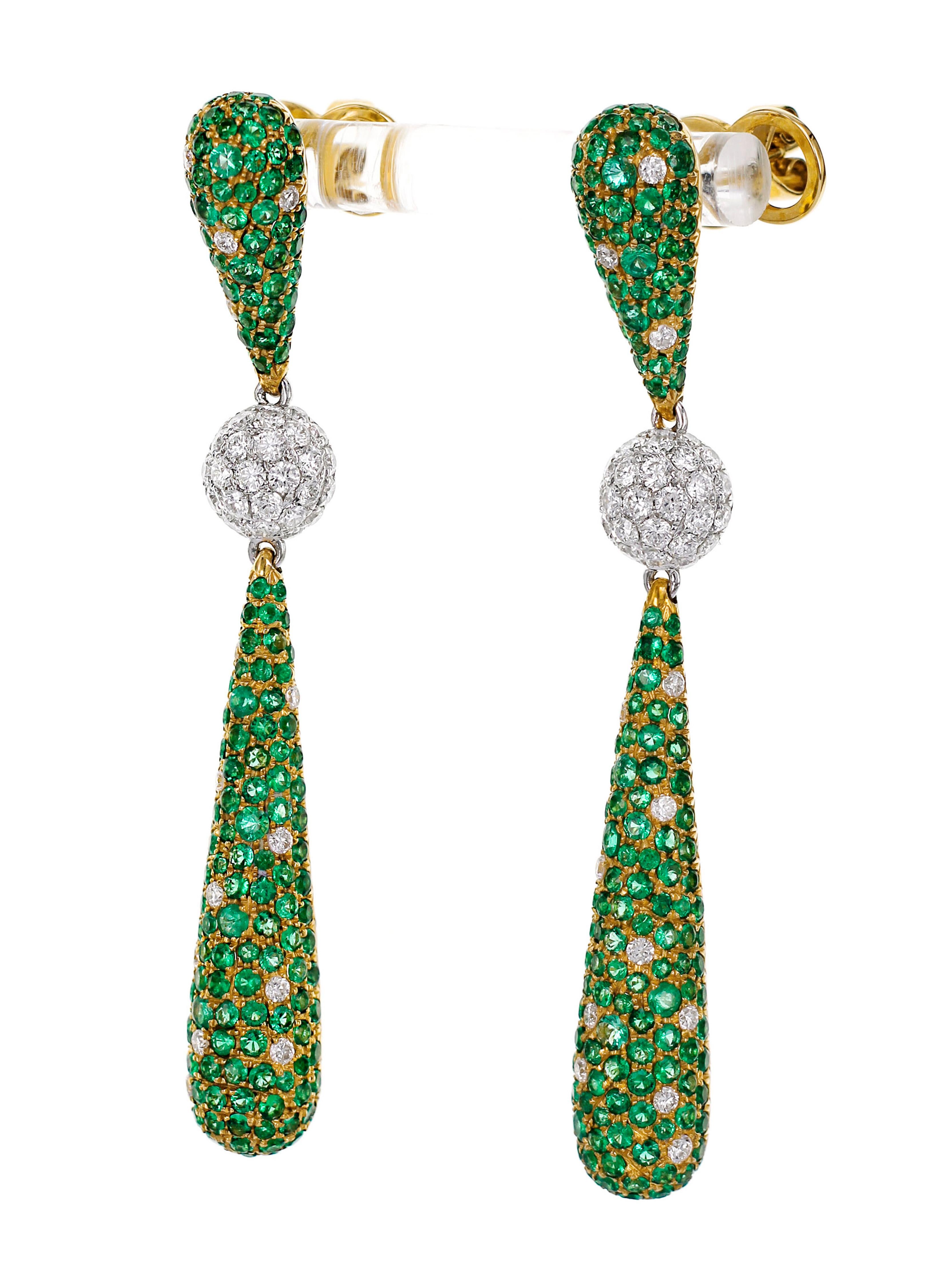 Vibrant 4.13 carat of Colombian emerald with 1.65 carat of F color VS clarity round white brilliant diamonds are studded in this classic dangle earring. 
With an intricate honeycomb backing, this earring will be head turner from all sides.