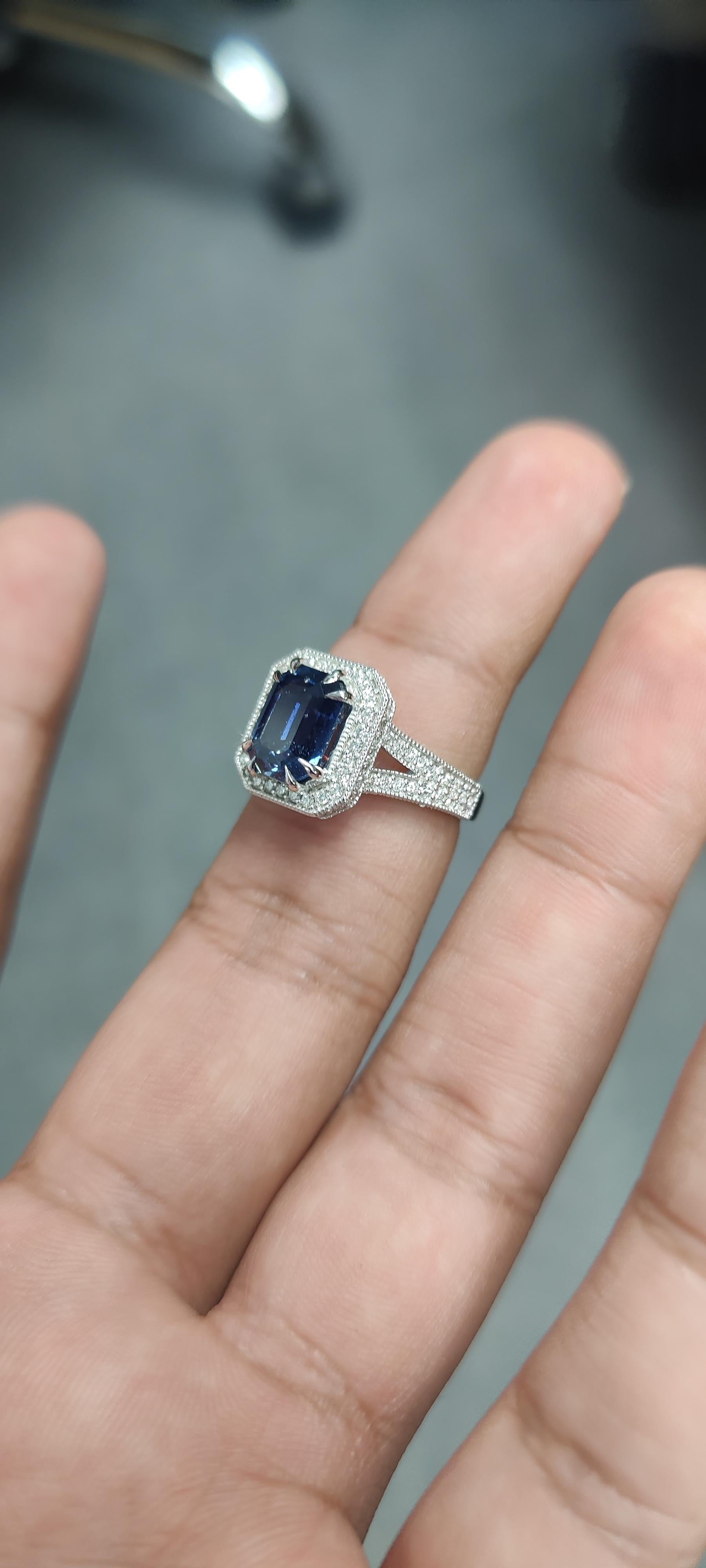 Introducing our dainty and gorgeous, 4.13 Carat Sapphire Ring! It's a true beauty, carefully crafted with attention to every detail. The centerpiece is a stunning Sapphire surrounded by shimmering diamonds, all set on a shiny 18K White Gold band.