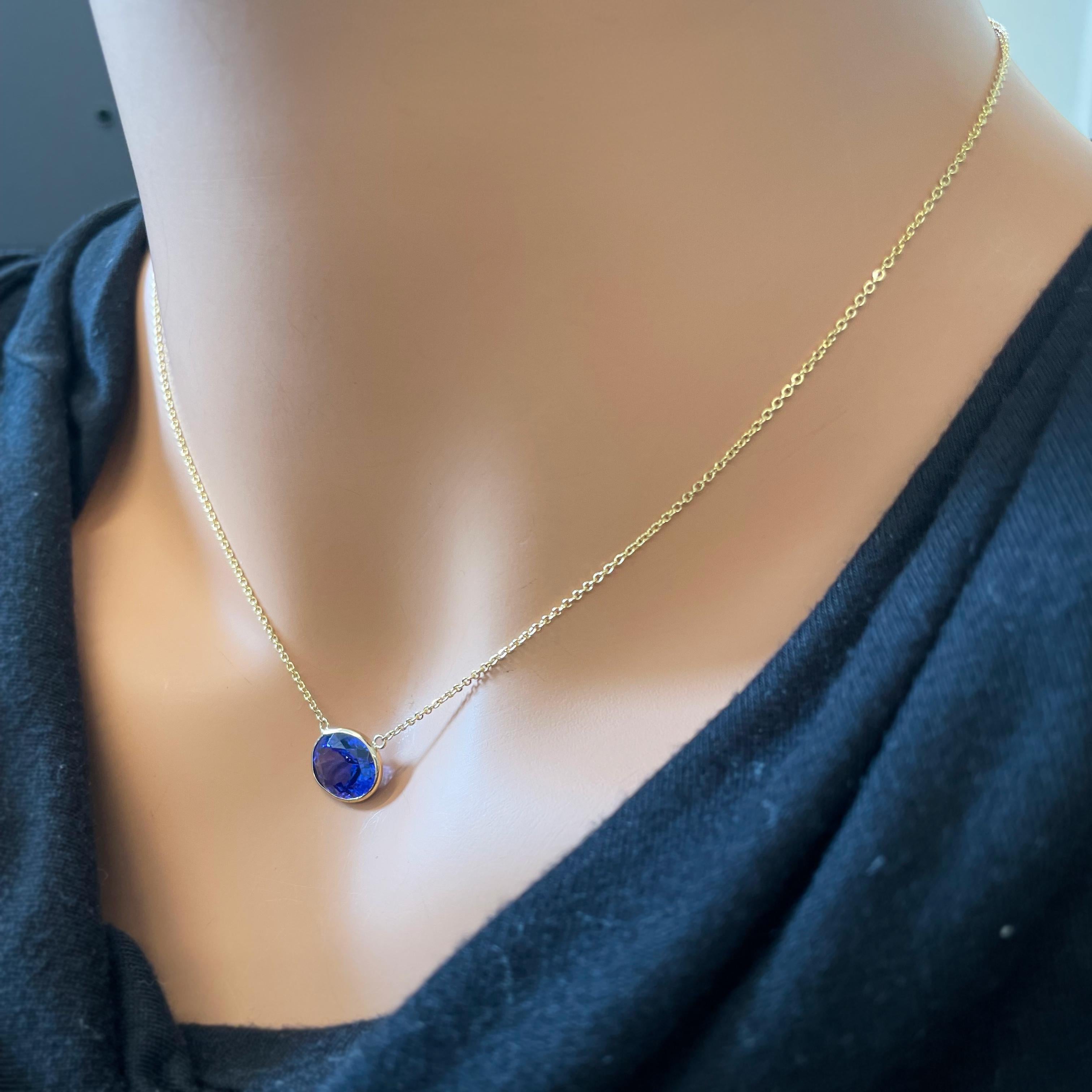 A fashion necklace featuring a blue oval tanzanite with a weight of 4.13 carats set in 14k yellow gold (14k YG) can be a striking and elegant accessory. The focal point of this necklace is a blue oval tanzanite with a significant weight of 4.13