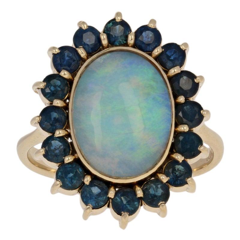 4.13 Carat Oval Cabochon Cut Opal and Sapphire Ring, 18 Karat Yellow Gold Halo