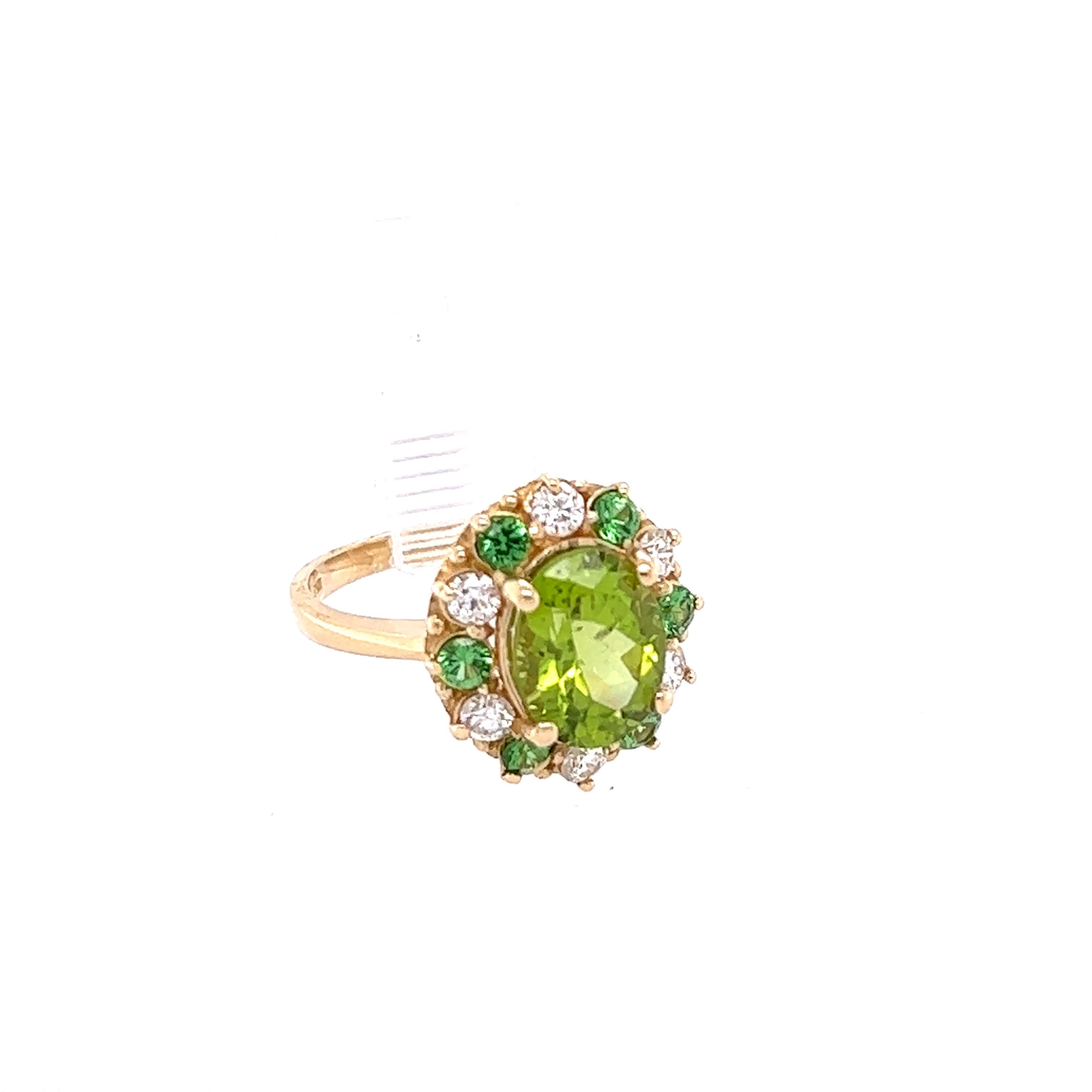 This ring has a Oval Cut Natural Peridot that weighs 3.14 carats. It is surrounded by 6 Round Cut Natural Diamonds that weigh 0.50 Carats, (Clarity: SI, Color: F) and 6 Round Cut Natural Tsavorites that weigh 0.49 carats. 
The total carat weight of