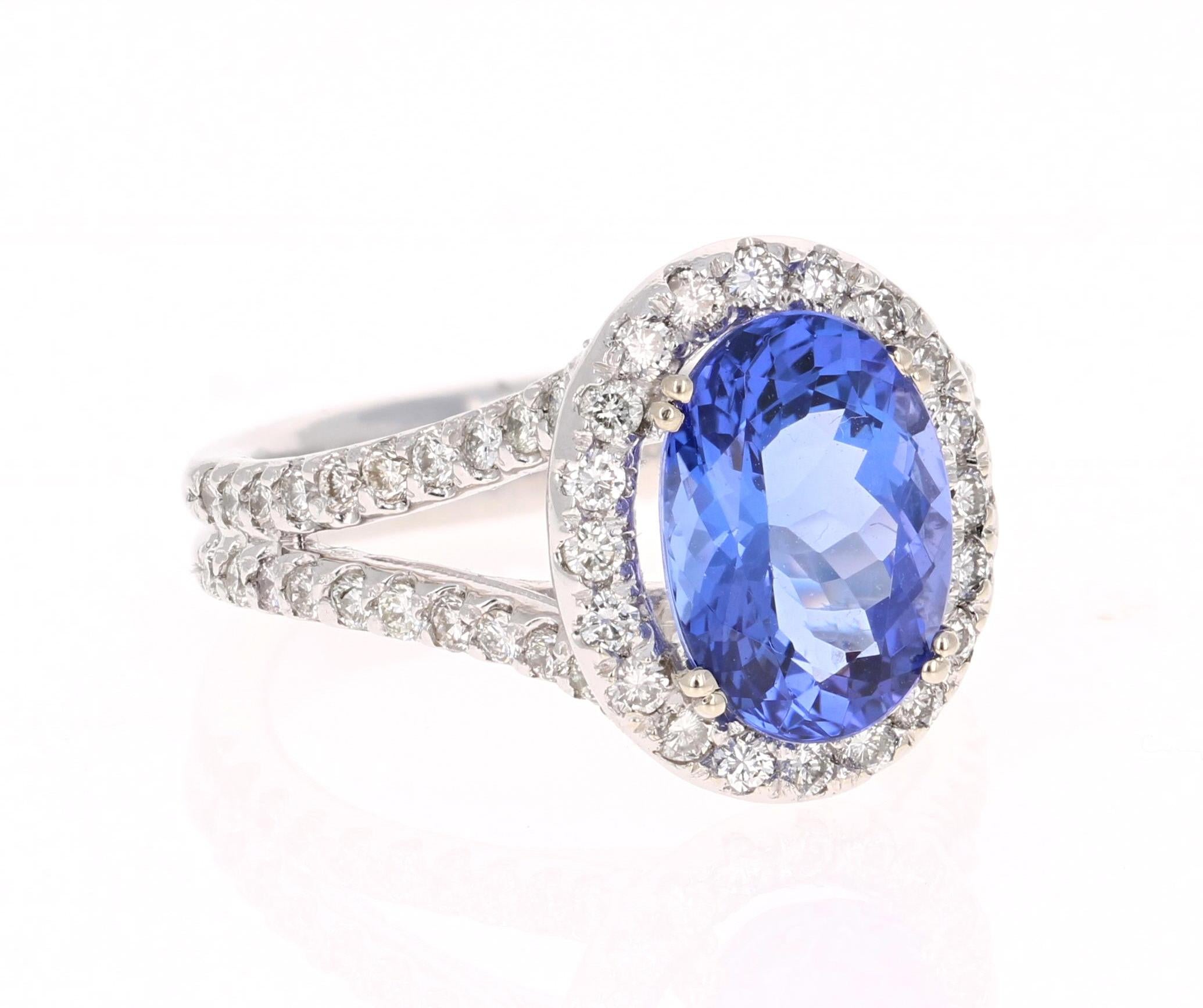 This beautiful ring has a vivid 3.24 Carat Oval Cut Tanzanite. The Tanzanite is surrounded by 60 Round Cut Diamonds that weigh 1.23 carats with a stunning split shank setting. (Clarity: VS2, Color: F)  The total carat weight of the ring is 4.13
