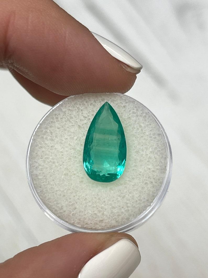 Stone: Emerald
Weight: 4.13-carats
Shape: Pear Cut
Clarity: Transparent, Bluish Green Color Bands are seen in this stone
Luster: Very Good
Color: Bluish Green
Measurements: 15.55mm x 8.3mm x 5.32mm
Geographic Origin: Colombia
Treatment: Natural,