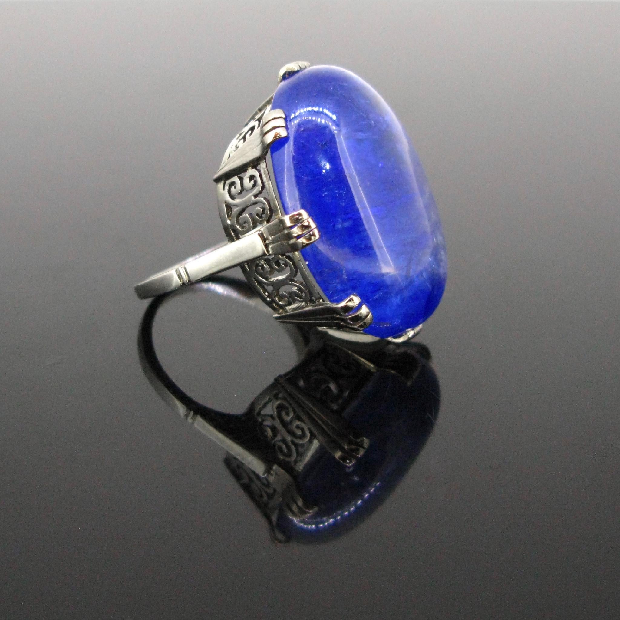 This important ring is set with a stunning indigo-blue tanzanite weighing 41.35ct. The mount is fully made in 18kt white gold; it has a nice gold scroll works. The ring is controlled with the French eagle’s head. It is a size J ½ - 5 ½ - 51.

The