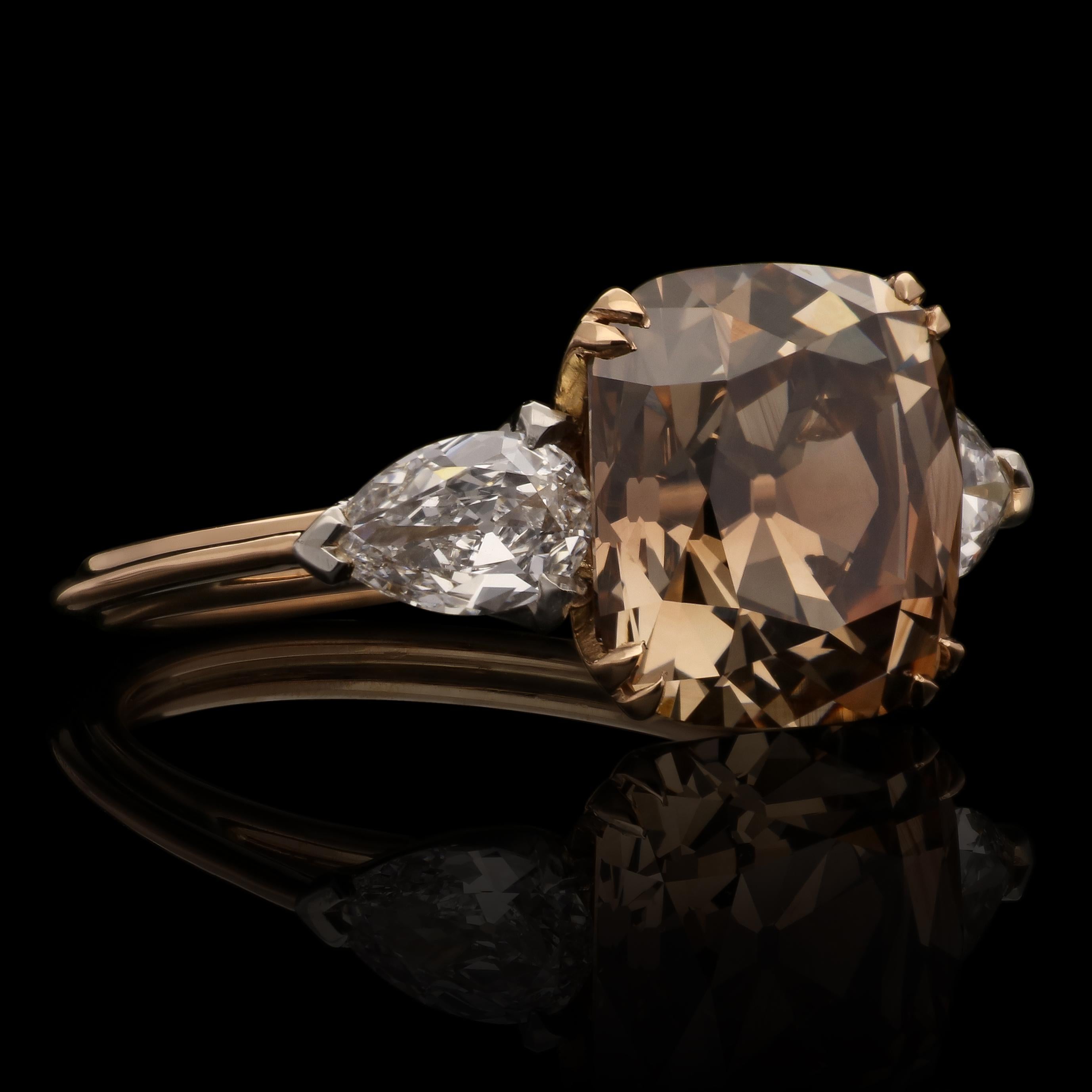 A beautiful old cut fancy diamond and white diamond ring by Hancocks, centred with a wonderful old mine brilliant cut diamond weighing 4.13cts and of Fancy Dark Orangey-Brown colour and VVS2 clarity, corner claw set in 18ct rose gold with open scoop