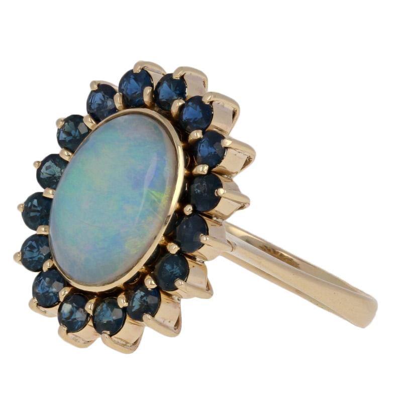 Oval Cut 4.13 Carat Oval Cabochon Cut Opal and Sapphire Ring, 18 Karat Yellow Gold Halo
