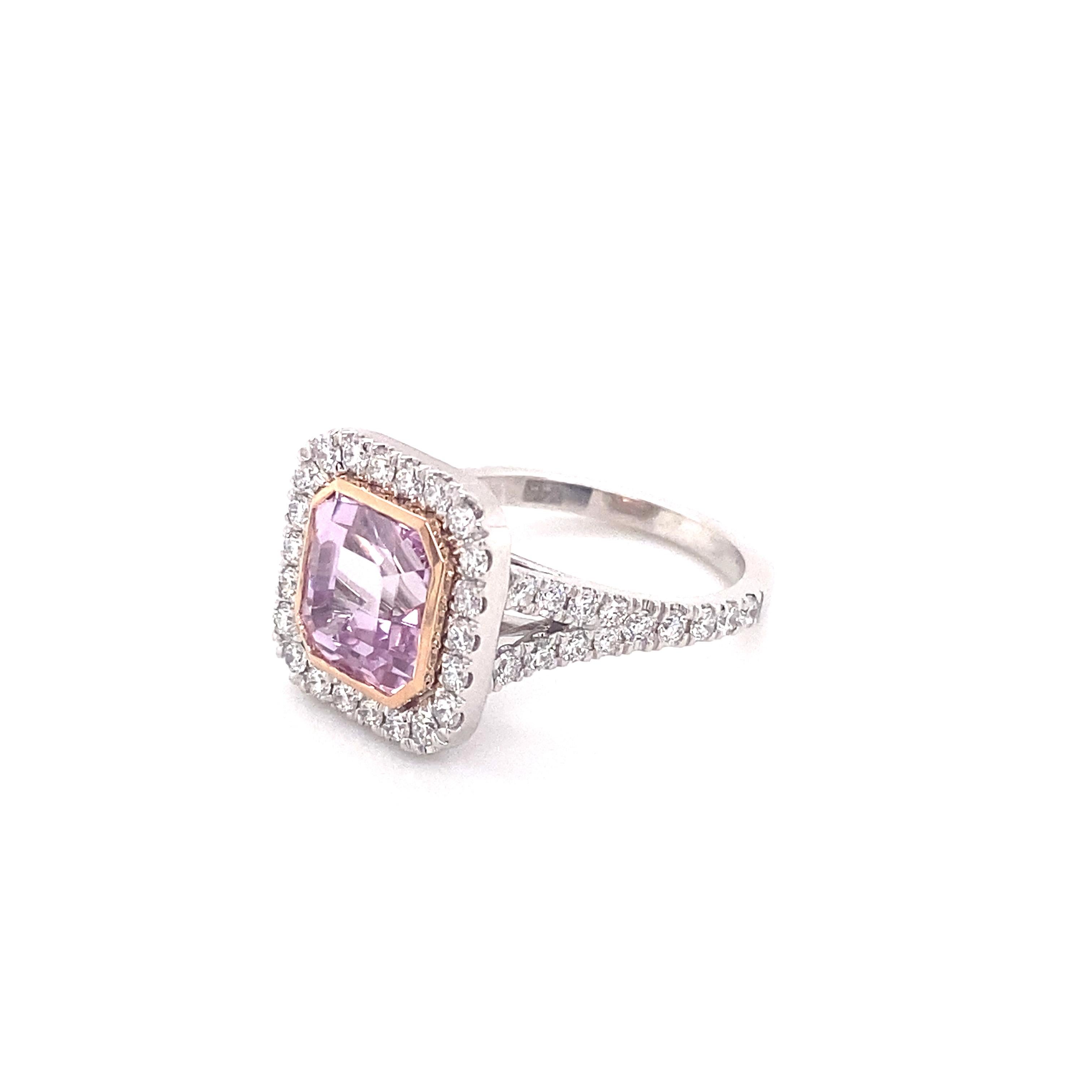 This beauty of a ring features a 4.14 carat natural purple-pink sapphire, no heat, set in a 14 karat white gold cushion shaped split shank halo ring with .90ctw round brilliant cut diamonds. The sapphire is surrounded by a 14 karat rose gold asscher