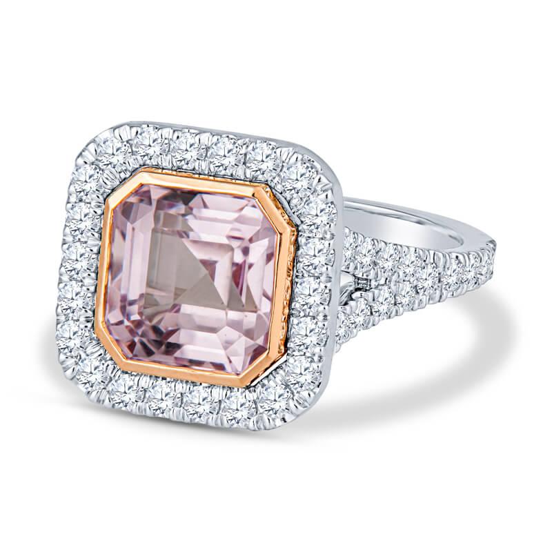 This beauty of a ring features a 4.14 carat natural purple-pink sapphire, no heat, set in a 14 karat white gold cushion shaped split shank halo ring with .90ctw round brilliant cut diamonds. The sapphire is surrounded by a 14 karat rose gold asscher