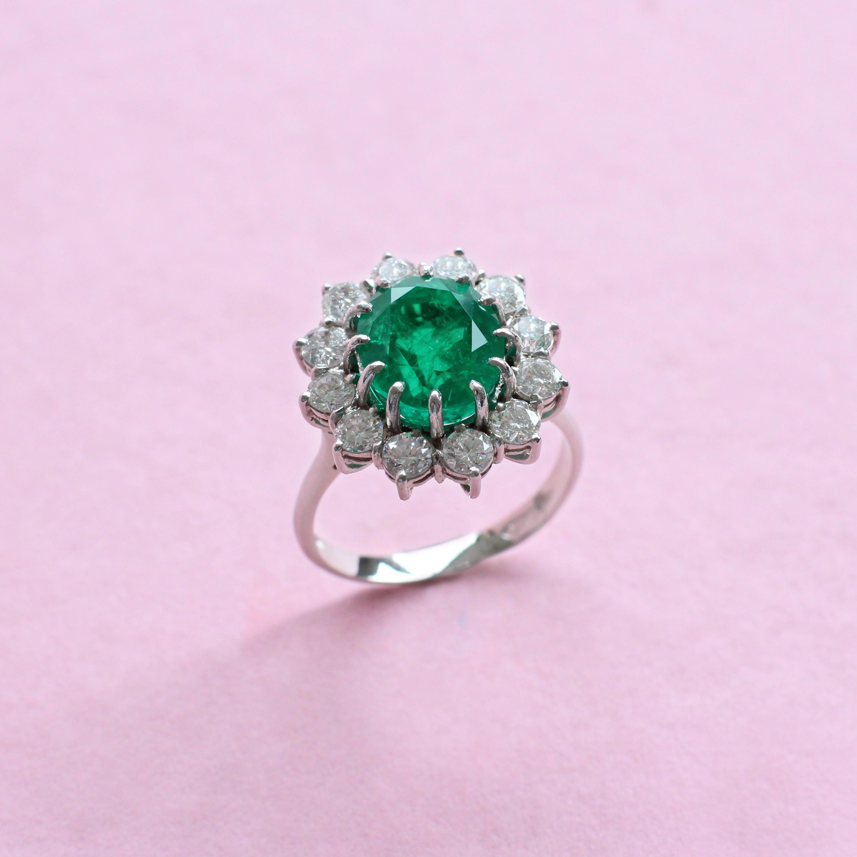 Oval Cut 4.15 Carat Emerald Ring with White Diamond Halo