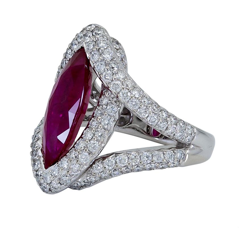 A special engagement ring style showcasing a long marquise cut ruby, set in a chic intertwined halo design micro-pave set with round brilliant diamonds. A truly beautiful piece of jewelry.
Ruby weighs 4.15 carats.
Diamonds weigh 0.32 carats