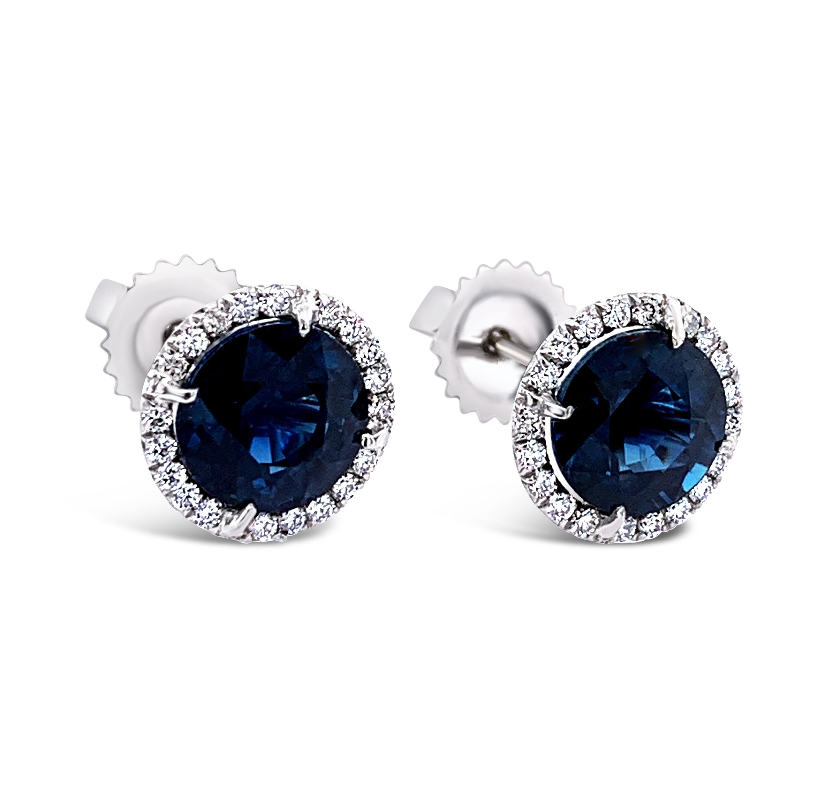 4.15 Carat (total weight) Sapphire and Diamond Halo Stud Earrings in 18K White Gold.  Diamond halos weigh 0.30 Carat (total weight) and have a color grade of H-I and clarity of SI-1 to SI-2.  The earrings measure 9.5mm across.
