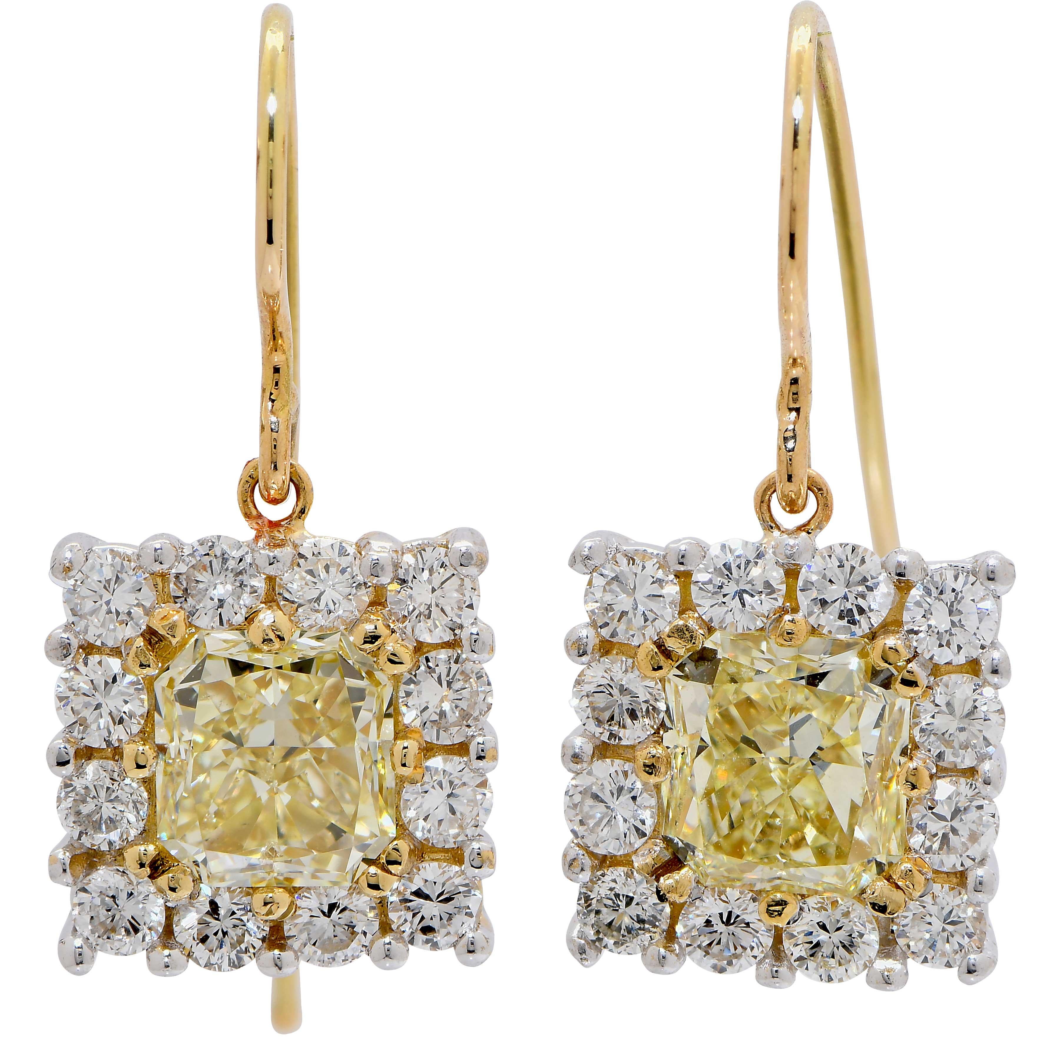 4.15 Carat Yellow and White Diamond Drop Earrings in 18 Carat Yellow Gold. These whimsical earrings feature two radiant cut yellow diamonds with a total weight of 3.02 carats and 24 white round diamonds with a total weight of 1.03 carats. 
Metal