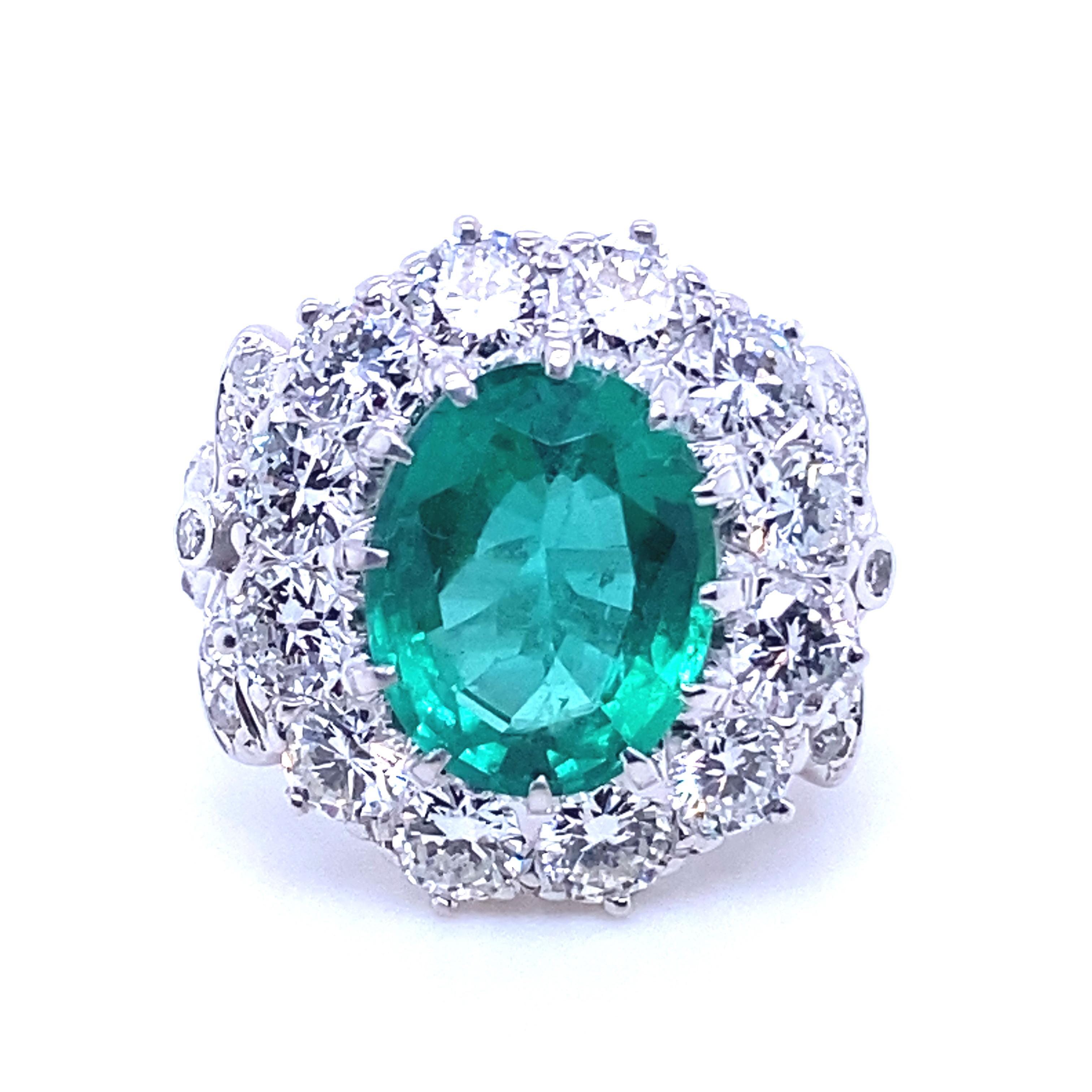 A 4.15 carat Zambian emerald and diamond cluster 18 karat white gold engagement ring.

This exceptional ring is set to its centre with an oval cut emerald of 4.15 carats with an accompanying certificate from The Gem and Pearl Laboratory, London