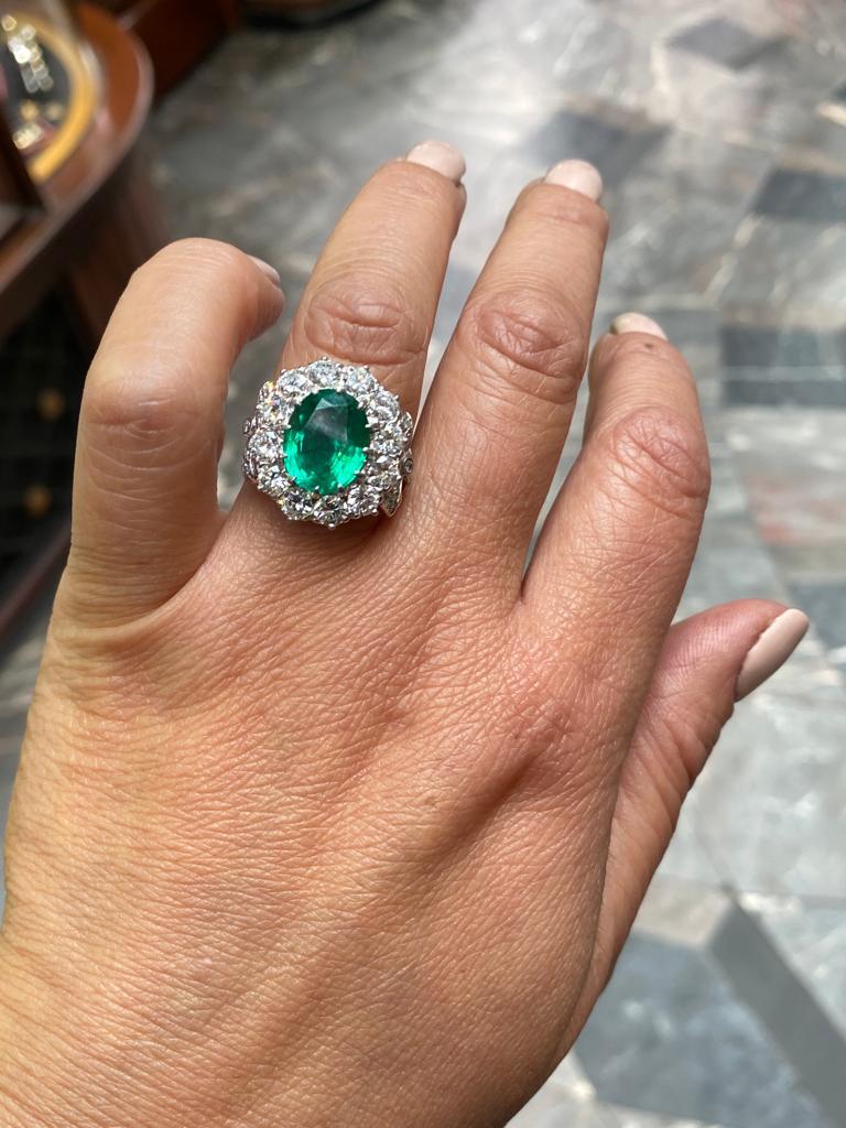 Oval Cut 4.15 Carat Zambian Emerald and Diamond Cluster 18 Kt White Gold Engagement Ring For Sale