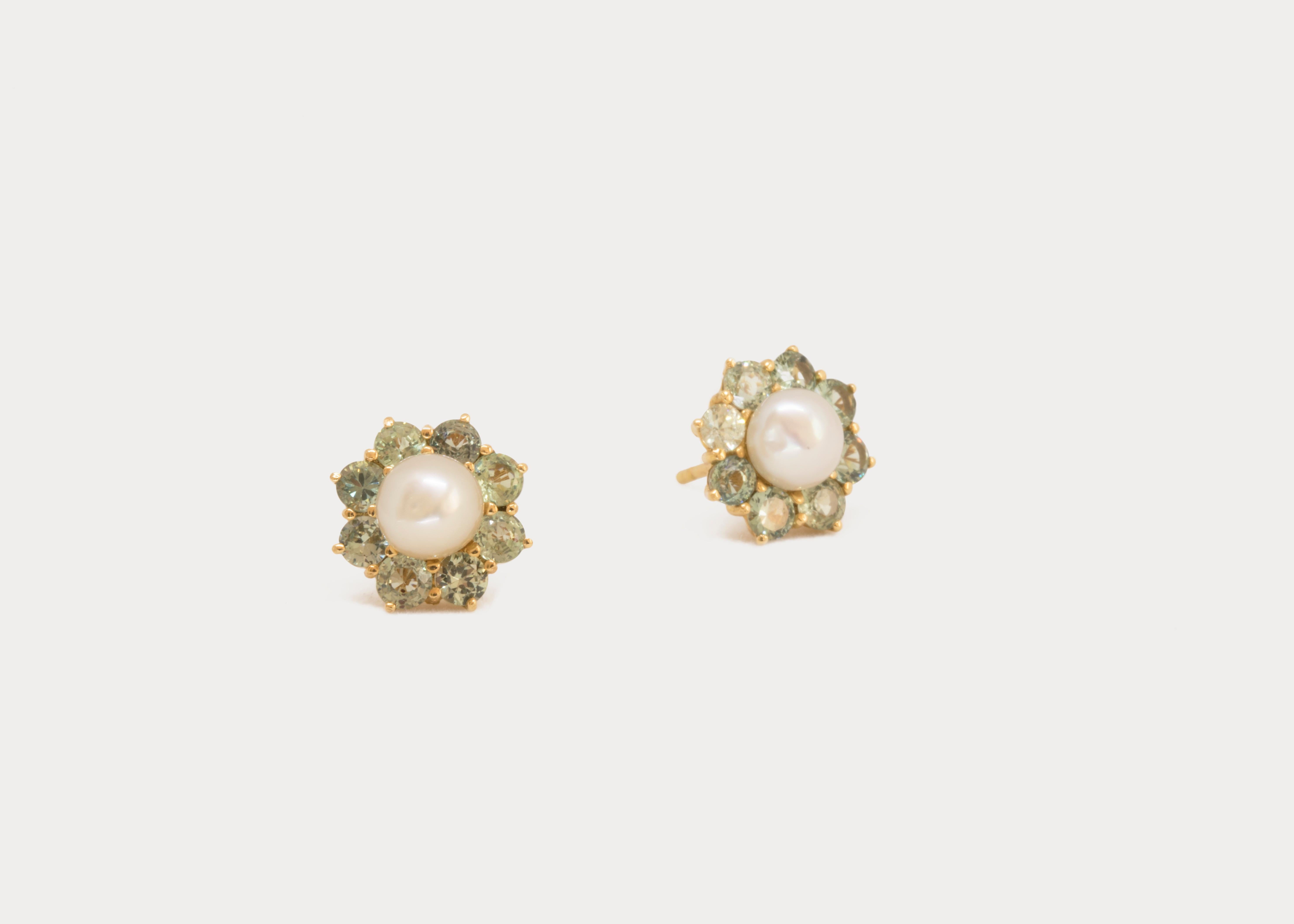 Greenish-yellow tourmalines are surrounded by an armor of smaller tourmalines studded on a 18k yellow gold border.
The natural pearl studs may be detached and worn separately. 

*This piece is one of a kind.

Gold Weight: 20 g
Pearl Weight: 2.15