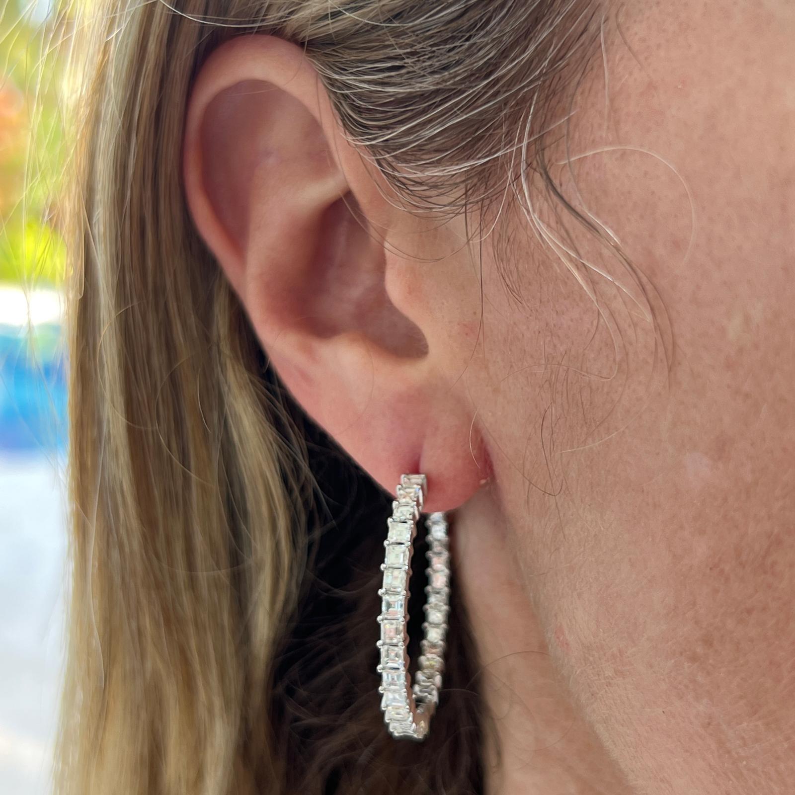 Modern and timeless diamond hoop earrings crafted in 18 karat white gold. The earrings feature 58 square emerald cut diamonds weighing 4.15 carat total weight. The diamonds are graded G-H color , VS clarity, and are set inside and outside the hoops.
