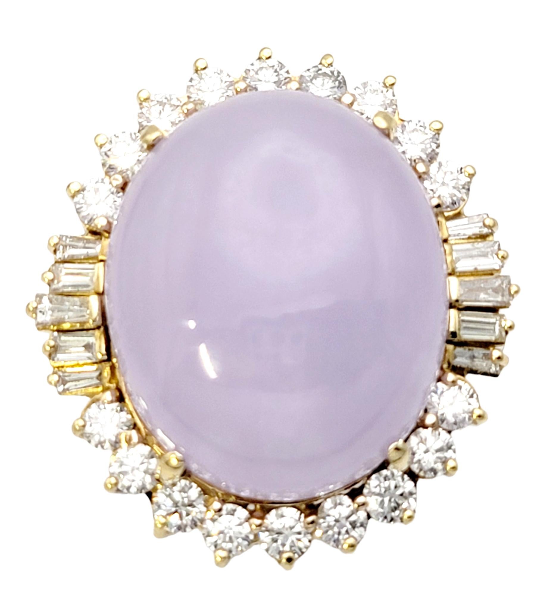 Ring size: 7

This jaw dropping lavender jade and diamond halo cocktail ring has all the wow factor you've been looking for! Striking in both size and color, this spectacular piece will not go unnoticed. 

The stunning oval cabochon lavender jade
