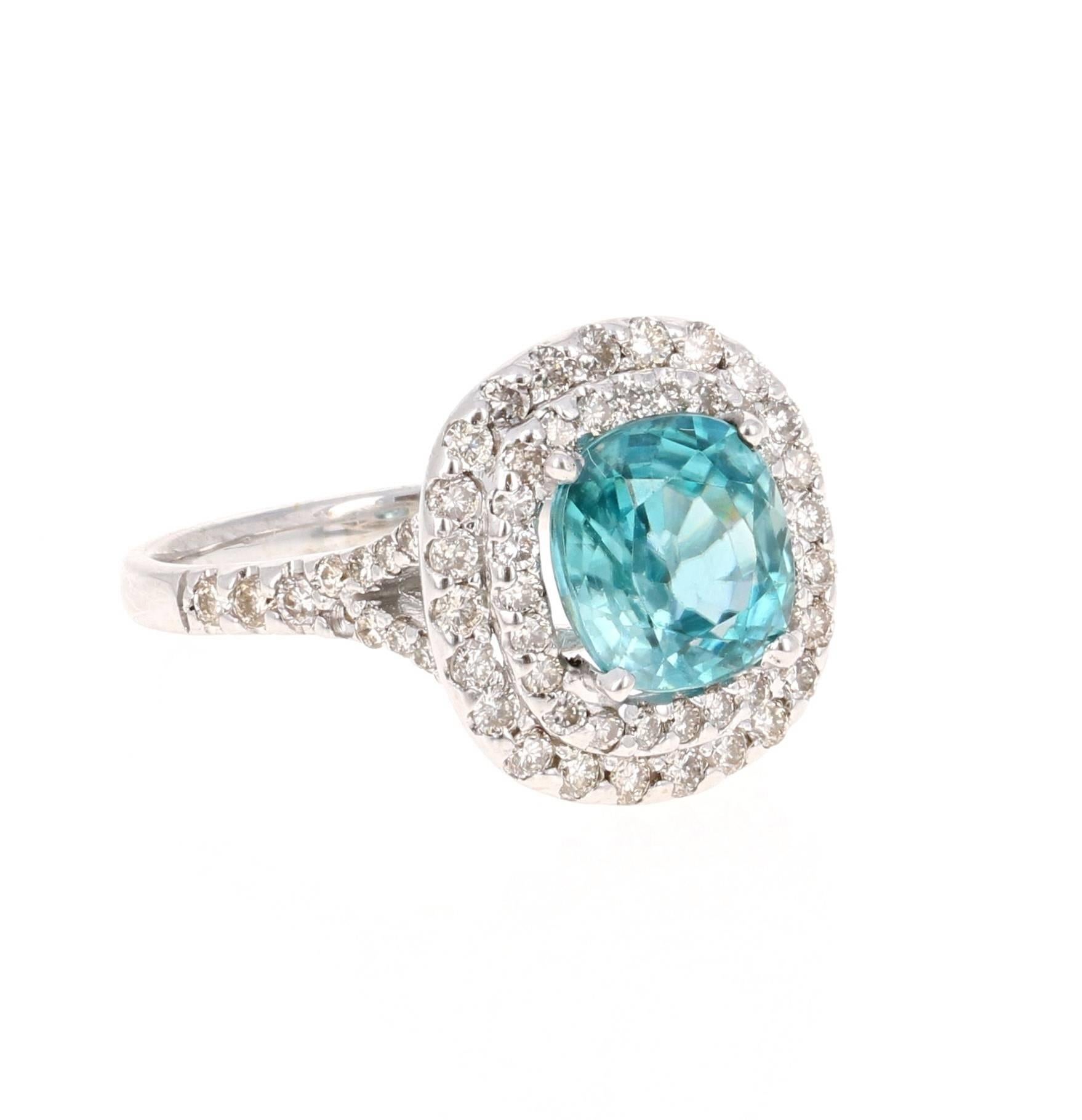 A Dazzling Blue Zircon and Diamond Ring! Blue Zircon is a natural stone mined in different parts of the world, mainly Sri Lanka, Myanmar, and Australia. 

This Oval Cut Blue Zircon is 3.31 carats surrounded by a double halo of 70 Round Cut Diamonds