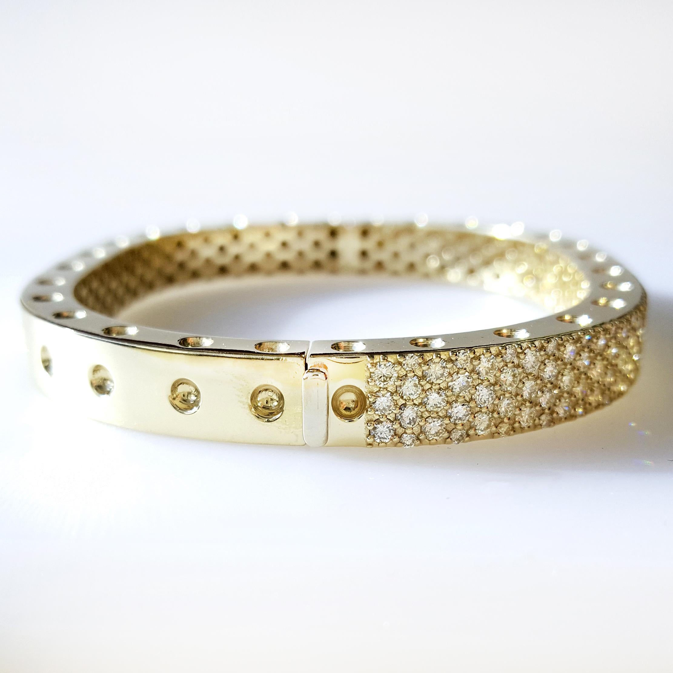This stunning two section 18 karat Yellow gold bangle style bracelet is accented with 171 carefully matched white round brilliant diamonds weighing approximately 4.16 carat total. Inspired by art and fashion, Novel Collection is presenting its