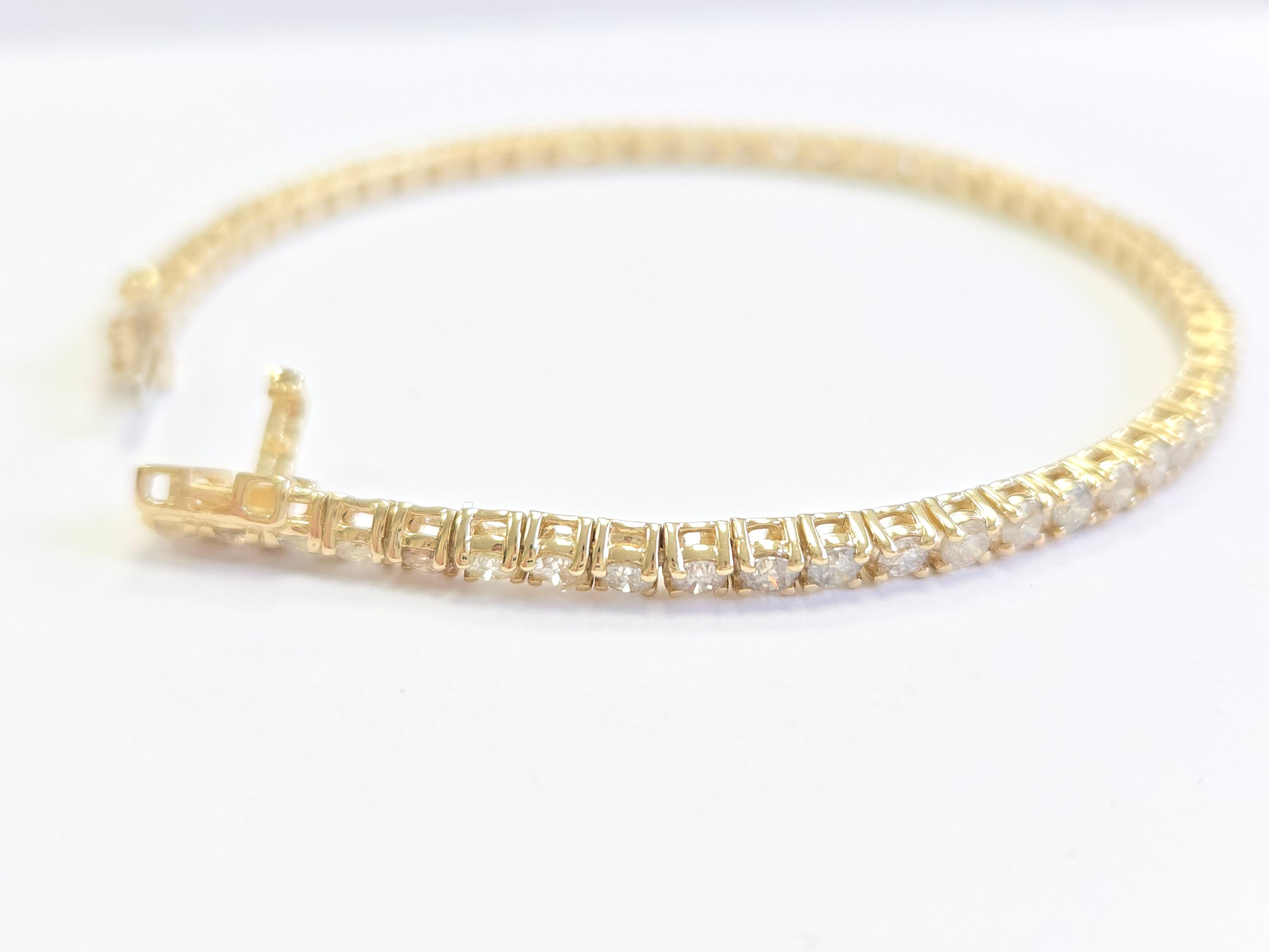 Ce bracelet de tennis exquis est orné de diamants blancs ronds de taille brillant, connus pour leur brillance et leur éclat exceptionnels. Sertis dans un style classique à quatre branches, les diamants sont soigneusement fixés pour maximiser la