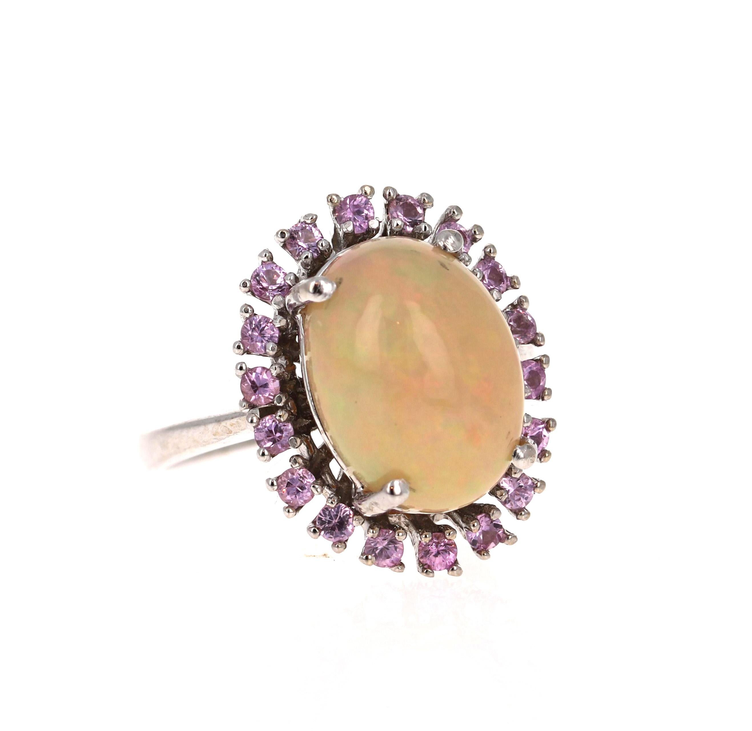 4.16 Carat Opal and Pink Sapphire 14 Karat White Gold Cocktail Ring 

This ring has a 3.50 Carat Oval Cut Opal and is surrounded by 18 Round Cut Pink Sapphires that weigh 0.66 Carats.  The total carat weight of the ring is 4.16 Carats.

The ring is