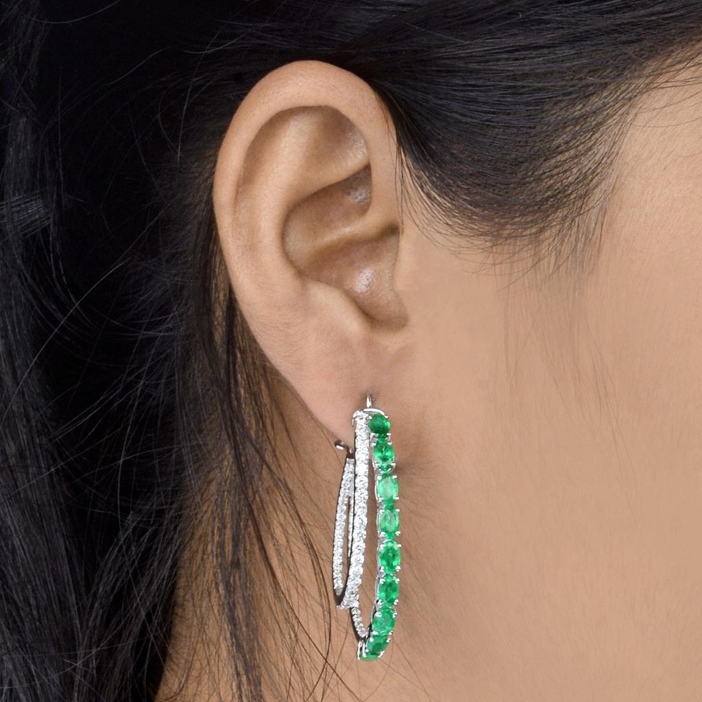Cast in 14-karat gold, these beautiful double hoop earrings are hand set with 4.16 carats of emerald and 1.60 carats of sparkling diamonds. 

FOLLOW  MEGHNA JEWELS storefront to view the latest collection & exclusive pieces.  Meghna Jewels is