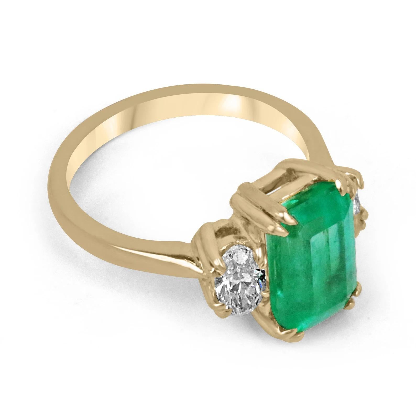 Who said love at first sight, wasn't a thing? This enthralling AAA+ TOP OF THE LINE ethically sourced Colombian emerald and oval diamond three-stone speaks for itself. The center stone features a captivating 3.44-carat, natural emerald cut Colombian