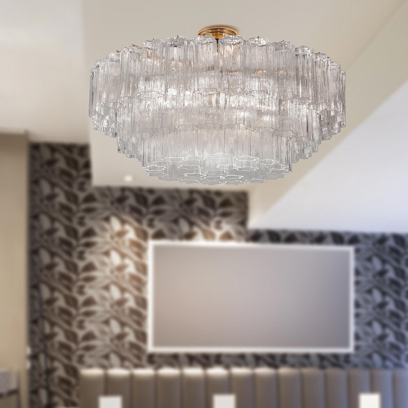 This incredible ceiling light offers a fantastic element of class and luxury to any modern style setting. Crafted in clear hammered glass with the main structure in a chrome or gold finish, this beautiful lighting fixture features an amazing and