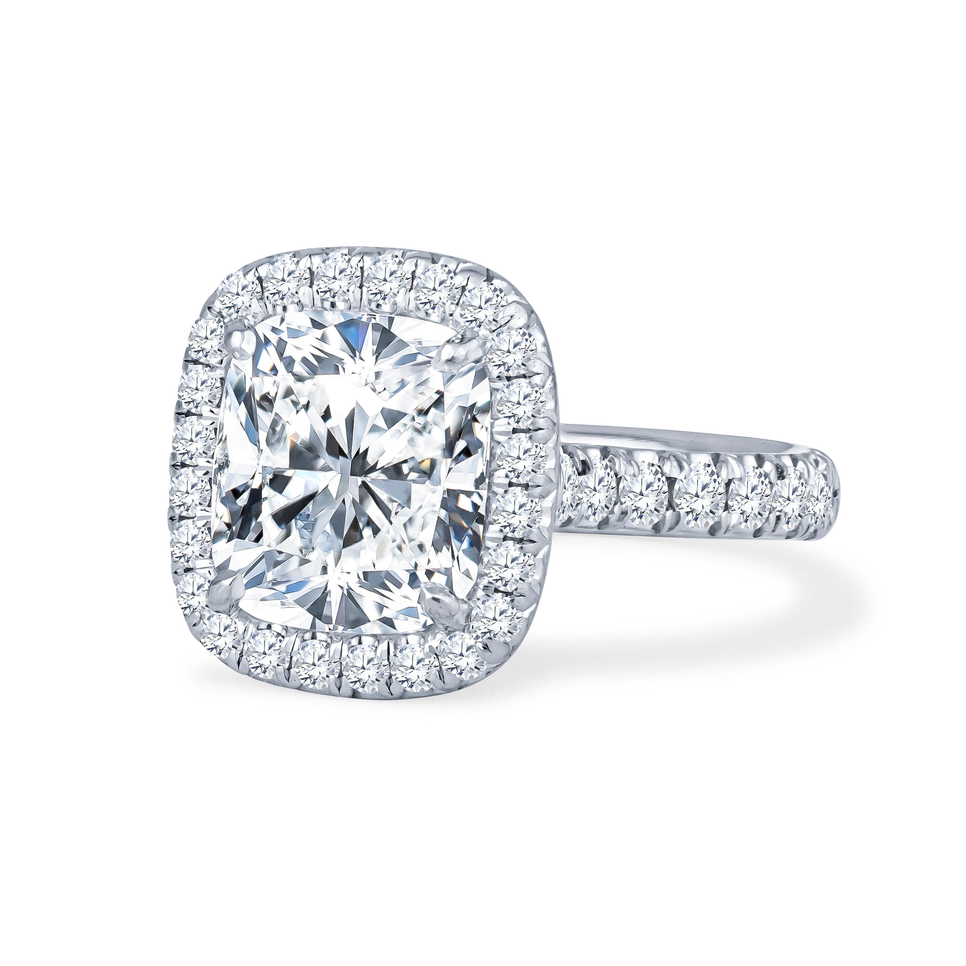 This breathtaking 4.18ct cushion cut natural diamond is set in a platinum halo engagement ring, with approximately 0.90ctw in surrounding diamonds. The ring is a size 6.25 but can be resized upon request. The diamond is GIA certified (Report