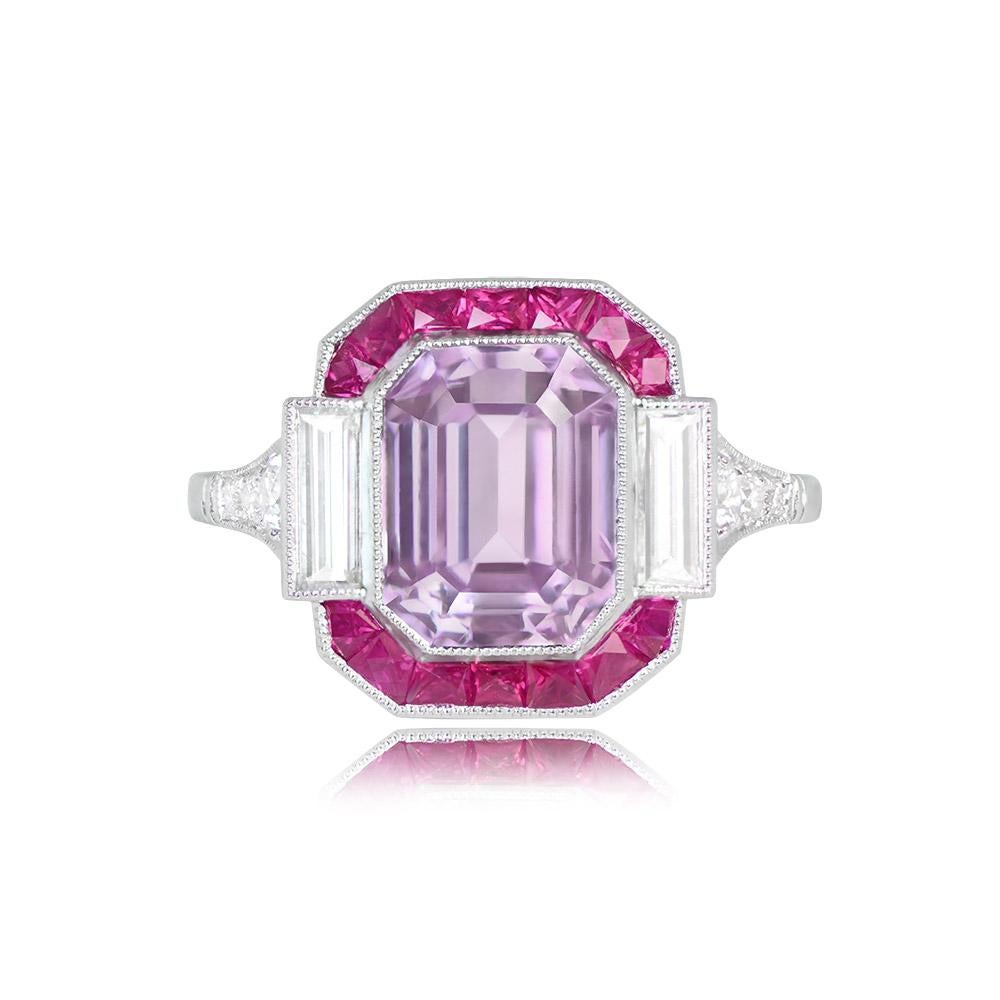 This stunning gemstone ring showcases a 4.18-carat emerald-cut kunzite with a beautiful pink hue. Flanked by two baguette-cut diamonds totaling approximately 0.40 carats, it also features a halo of French-cut rubies weighing about 0.42 carats in