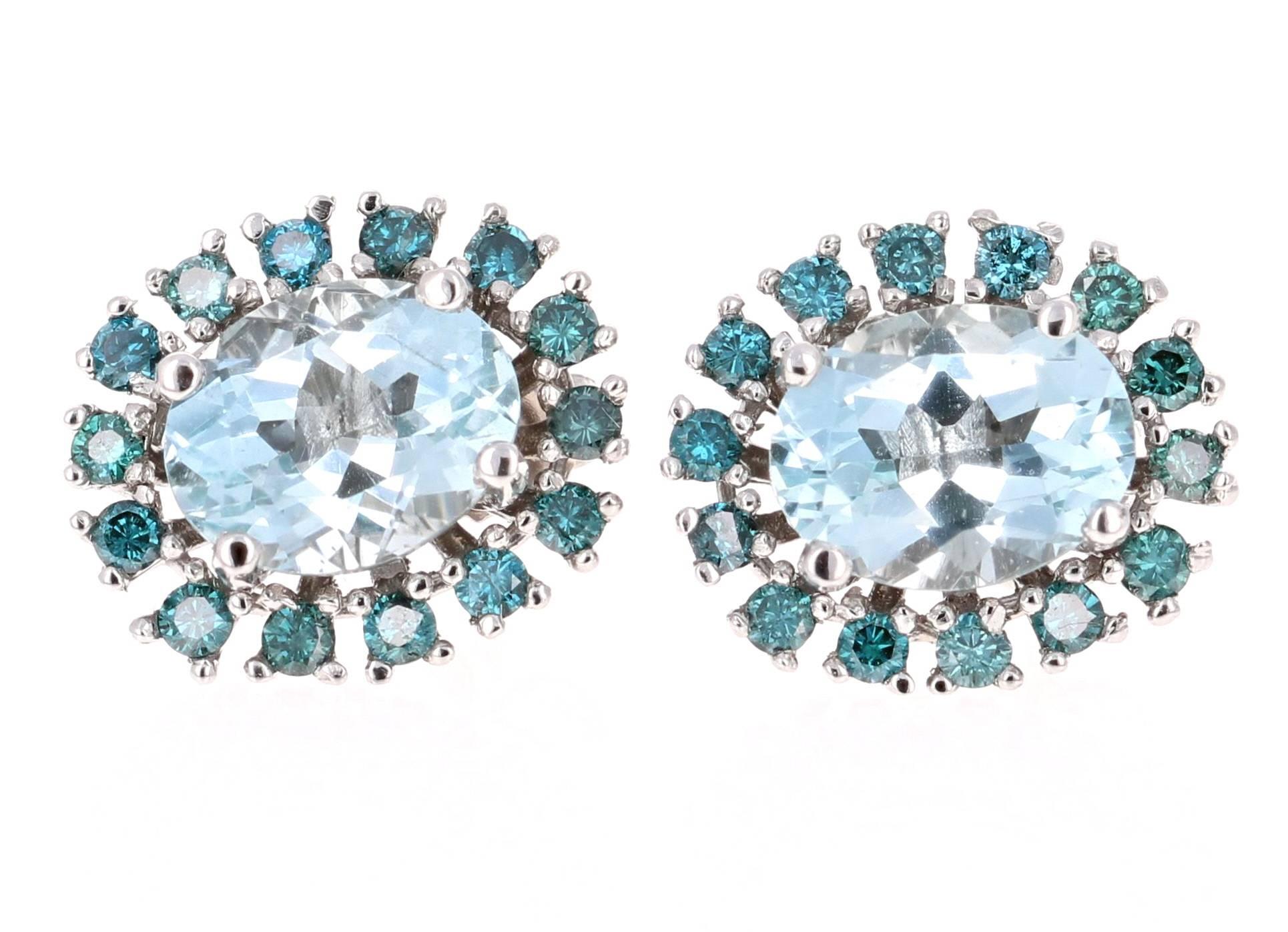 Super cute and unique Earrings made with pretty hues of Blue gemstones and diamonds.   
4.19 Carat Aquamarine and Blue Diamond White Gold Earring Studs!

There are 2 Oval Cut Aquamarines in the Earrings that weigh 3.46 Carats and they are surrounded