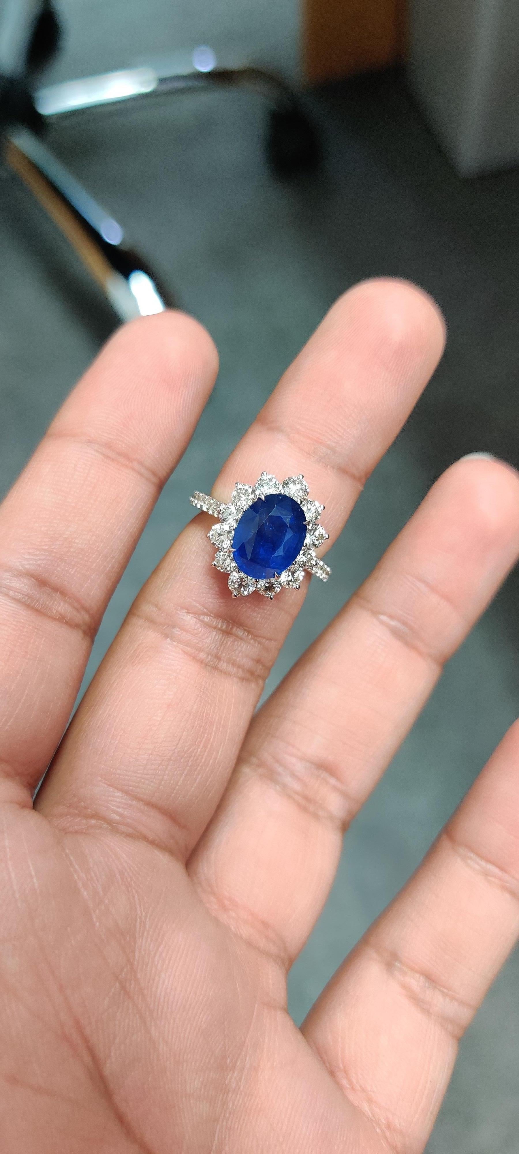 Introducing our stunning 18K Gold Oval Sapphire Ring, a true symbol of luxury and elegance. This exquisite piece features a captivating 4.19 carat oval sapphire, sourced from Sri Lanka, boasting a deep royal blue hue that commands attention and