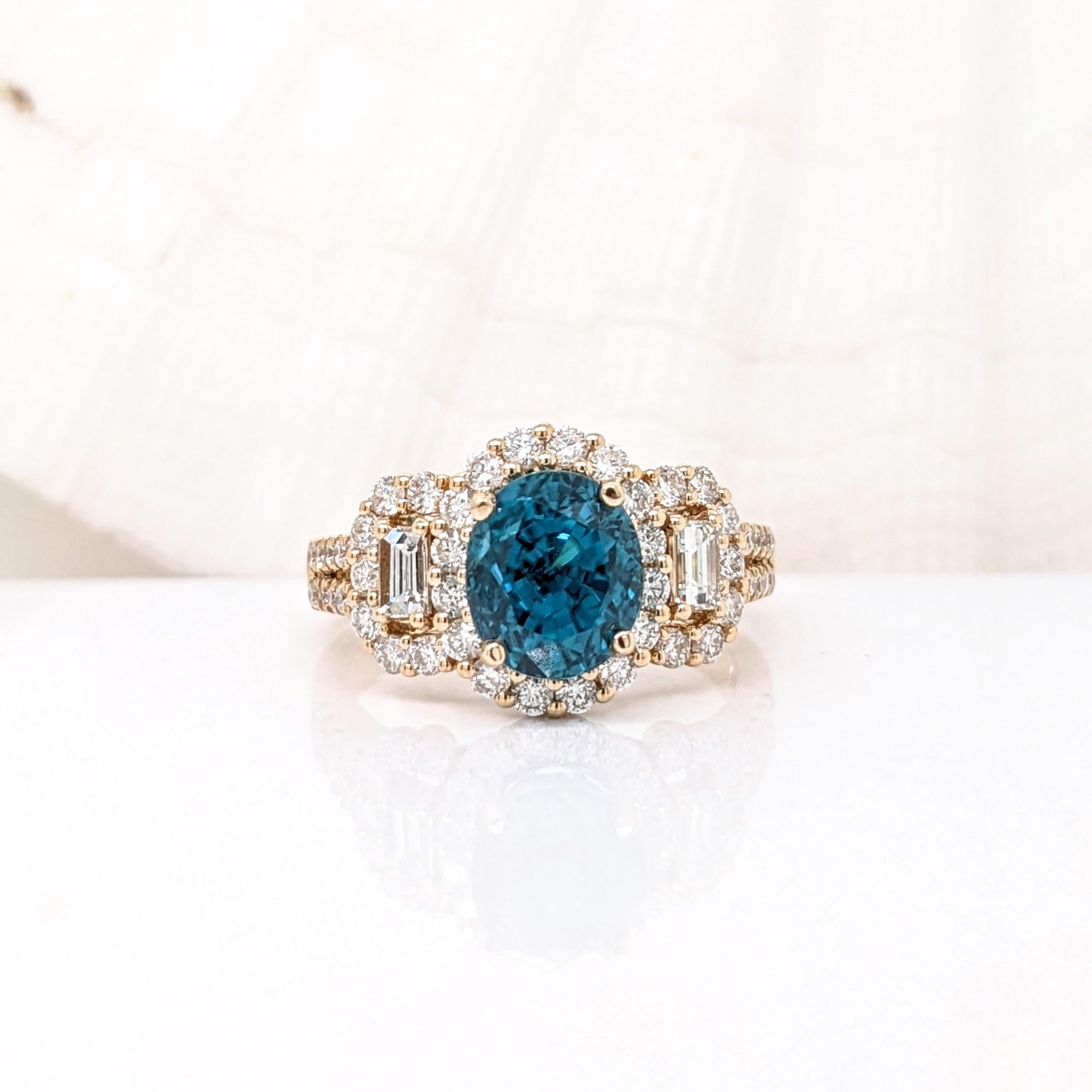 This statement ring features a stunning blue zircon in 14K solid yellow gold with beautiful baguette and round diamond accents and a unique split shank design. This collection ring makes for a gorgeous accessory to any look!

Fun Fact: Zircons are