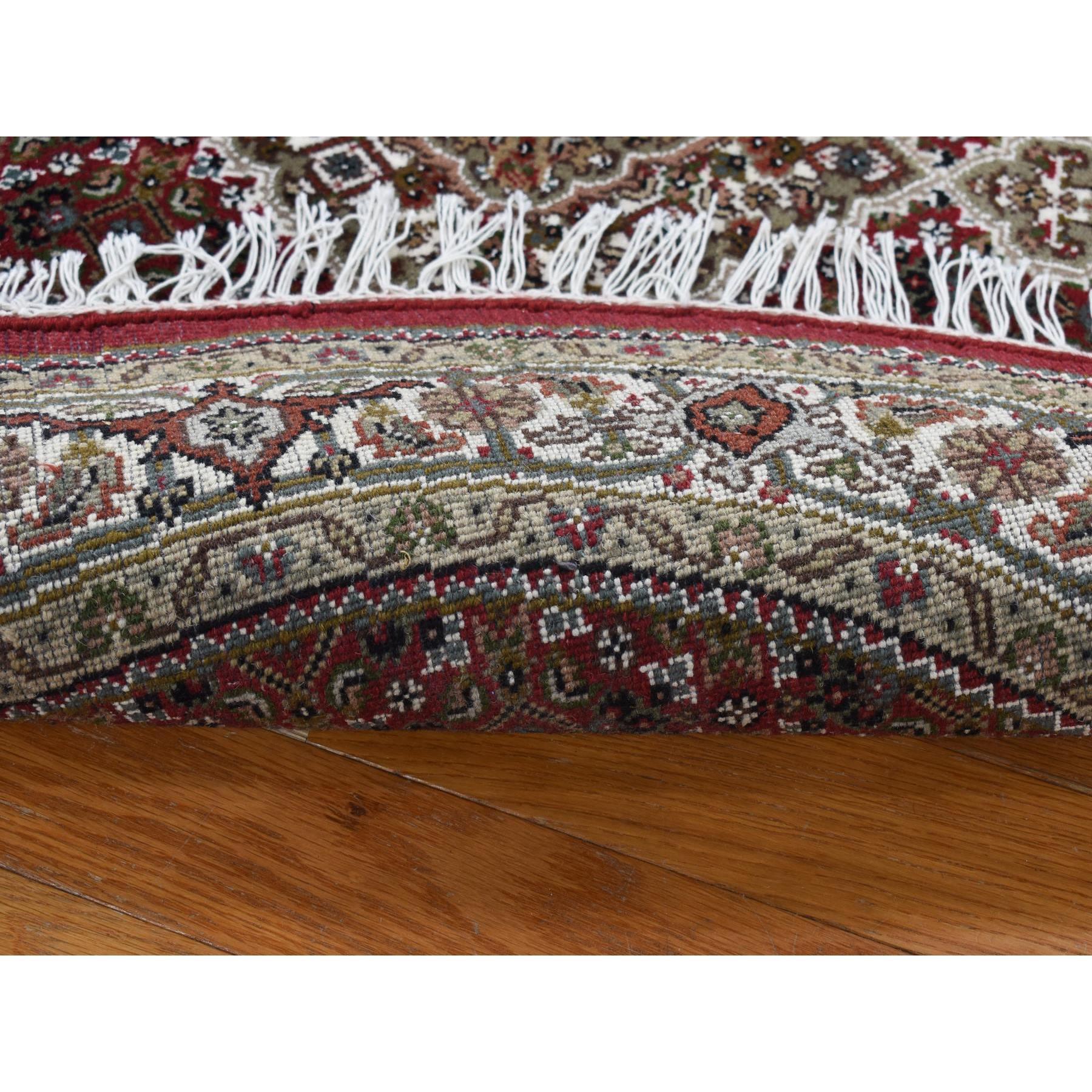 Vermilion Red, Tabriz Mahi, Pure Wool, Hand Knotted, Round Oriental Rug
Primary materials: Wool
Latex: No Pile 
height: 0.25 Inches
Style: Traditional
Primary color: Red
Secondary colors: Brown, Green, Gray, Black
Pattern: Oriental