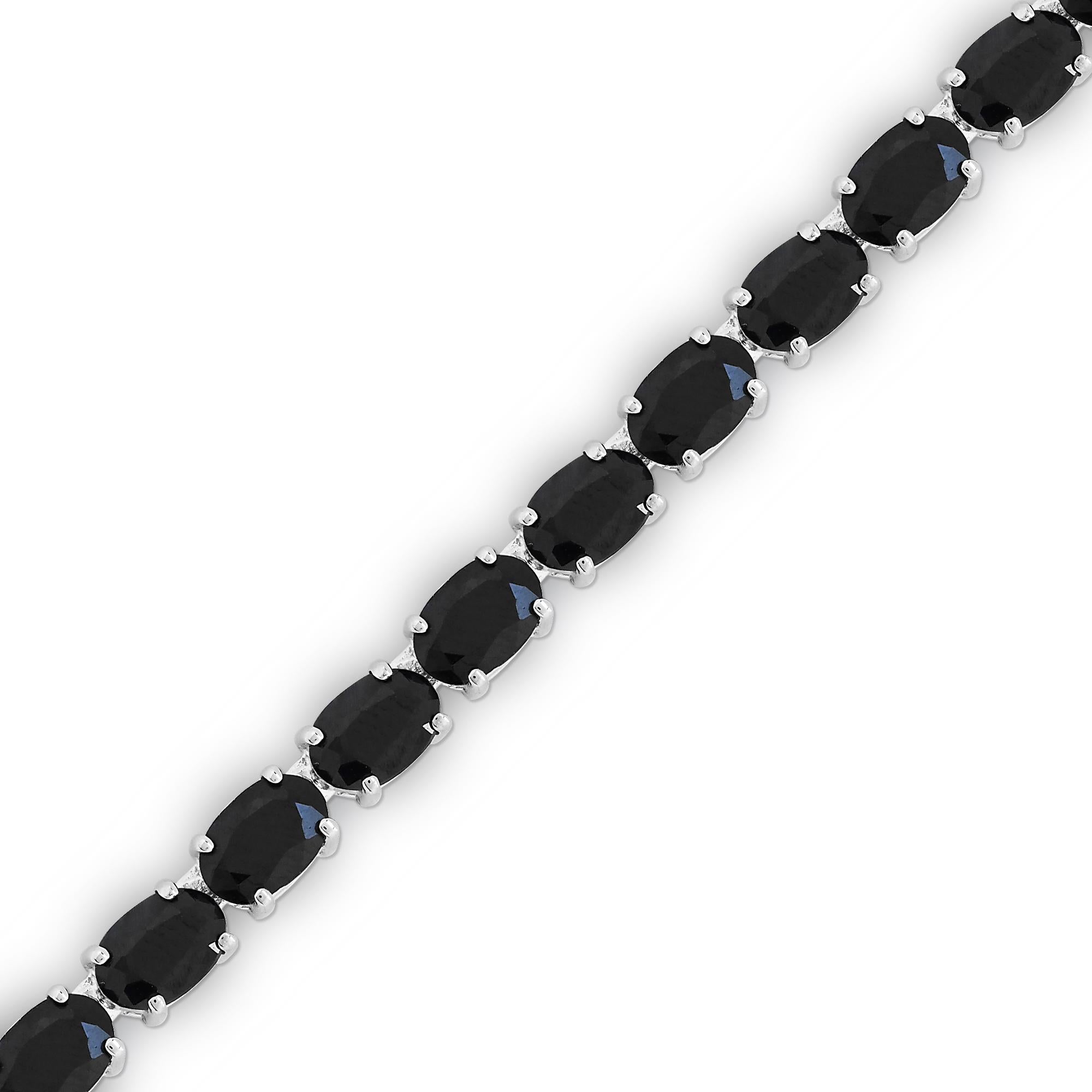 Indulge in the elegance of our 42-5/8 Carat Ultra Dark Blue Oval Sapphires 18