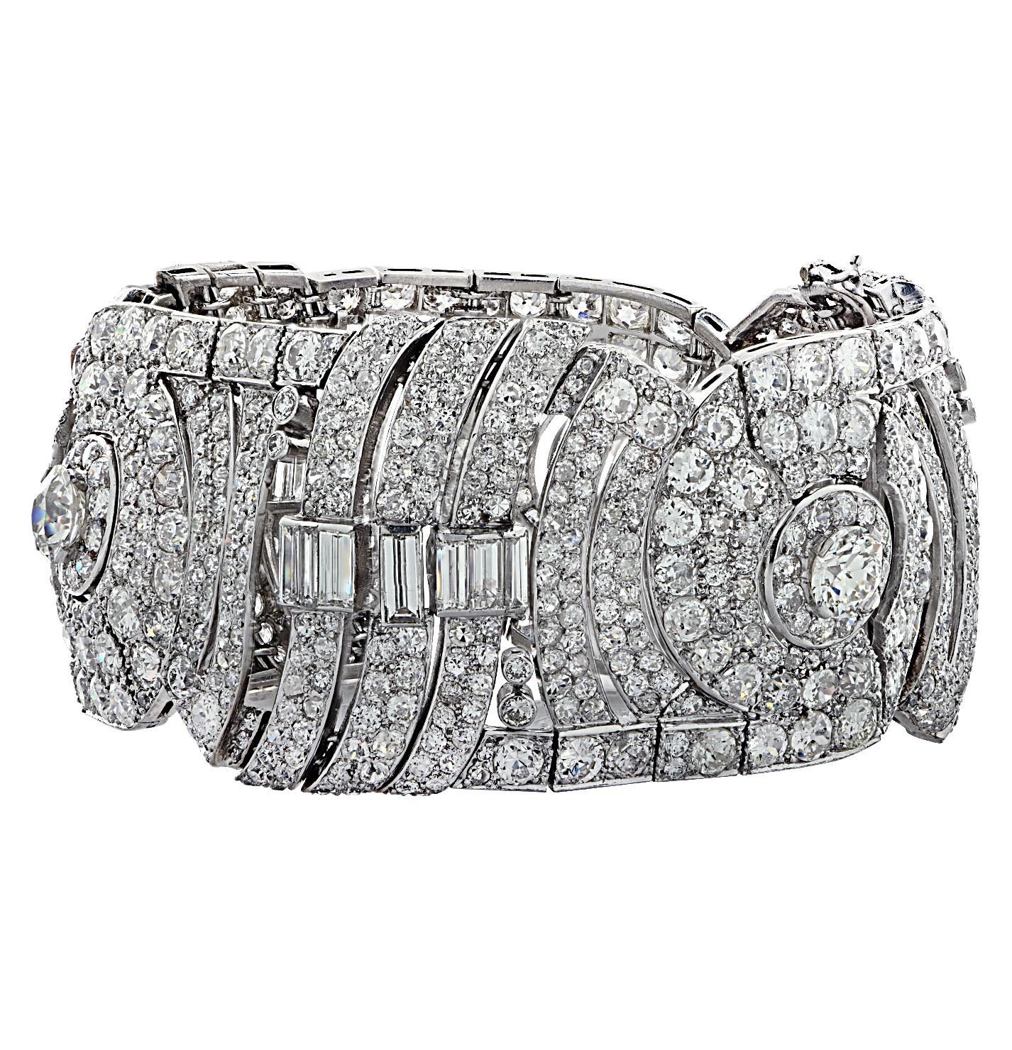 Exquisite Art Deco bracelet crafted in platinum, featuring Old European Cut Diamonds and Baguette Cut Diamonds weighing approximately 42 carats total, H-J color, VS-SI clarity. Diamond encrusted open plates showcase Old European cut diamonds set in