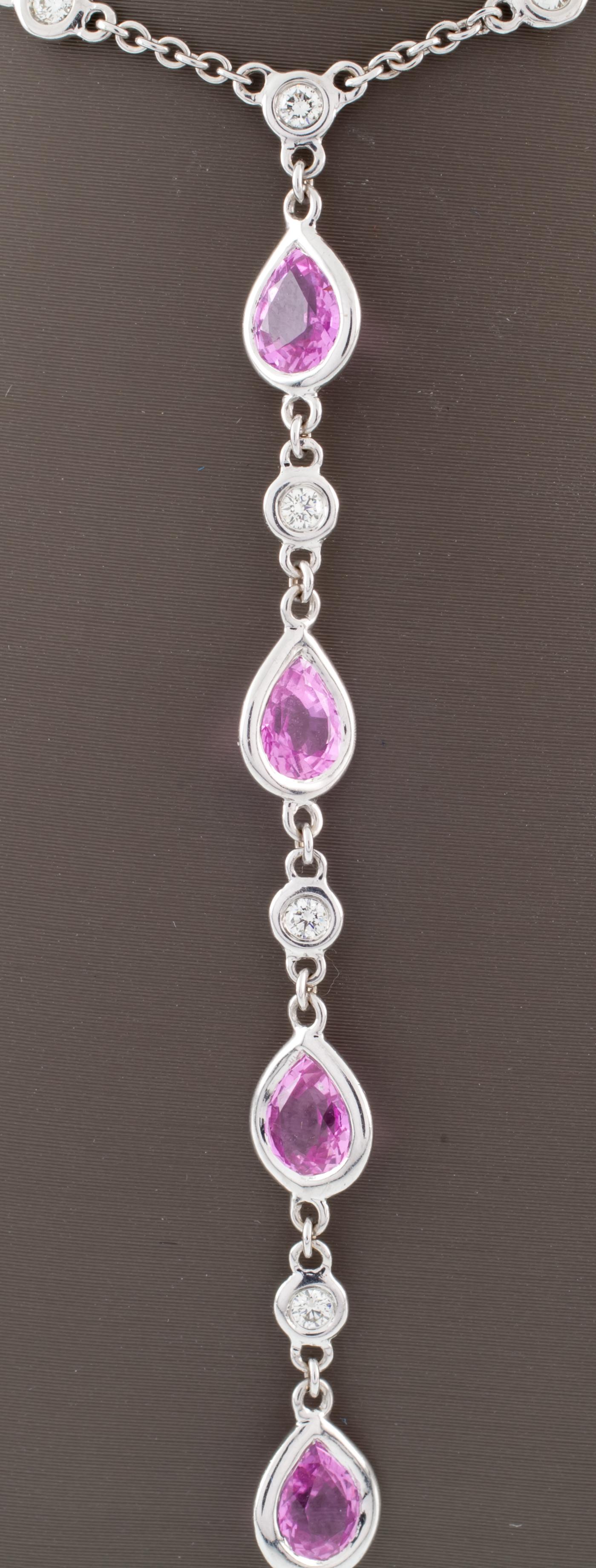 Gorgeous Pink Sapphire and Diamond Necklace
Features Bezel-Set Pear-Shaped Pink Sapphires in a Drop at Front
Length of Drop = 70 mm
18k Chain Features Periodic Bezel Set Round Diamonds in 