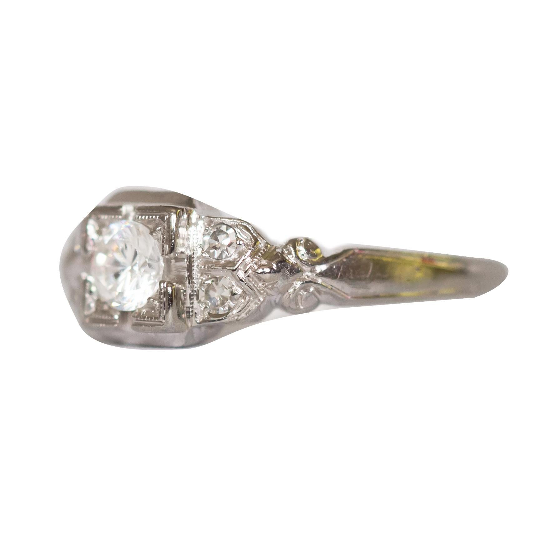 Ring Size: 6.5
Metal Type:  18 karat White Gold [Hallmarked, and Tested]
Weight: 2.5  grams

Center Diamond Details:
Weight: .42 carat
Cut: Old European Brilliant
Color: G
Clarity: SI1

Side Diamond Details:
Weight: .08 carat, total weight
Cut: Old