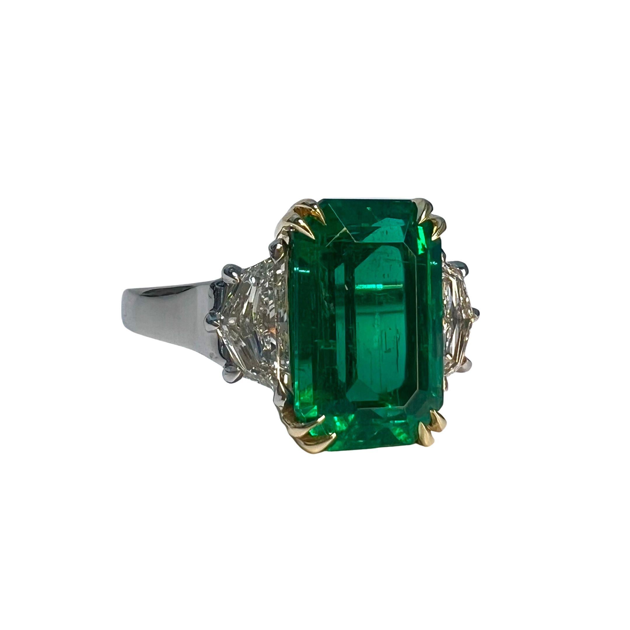 Emerald Weight: 4.23 CTs
Measurements: 12.38 x 7.95 x 5.93 mm
Diamond Weight: 0.84 CTs (G-VS)
Metal: Platinum/18K Yellow Gold 
Ring Size: 7
Shape: Emerald-Cut
Color: Green
Hardness: 7.5-8
Birthstone: May
CD Certified: 1009
Product ID: